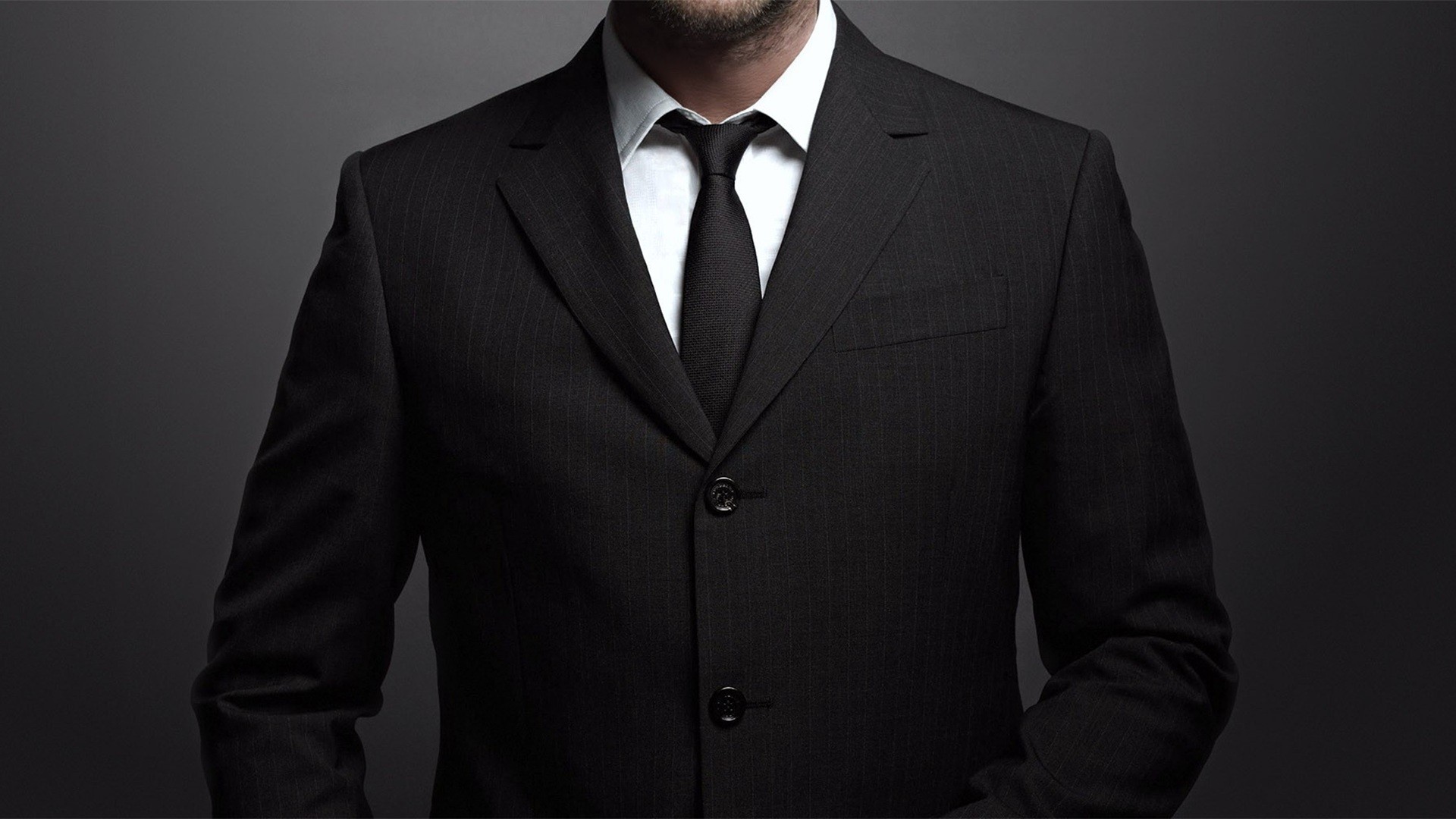 Man in a black pinstripe suit and tie HD Wallpaper