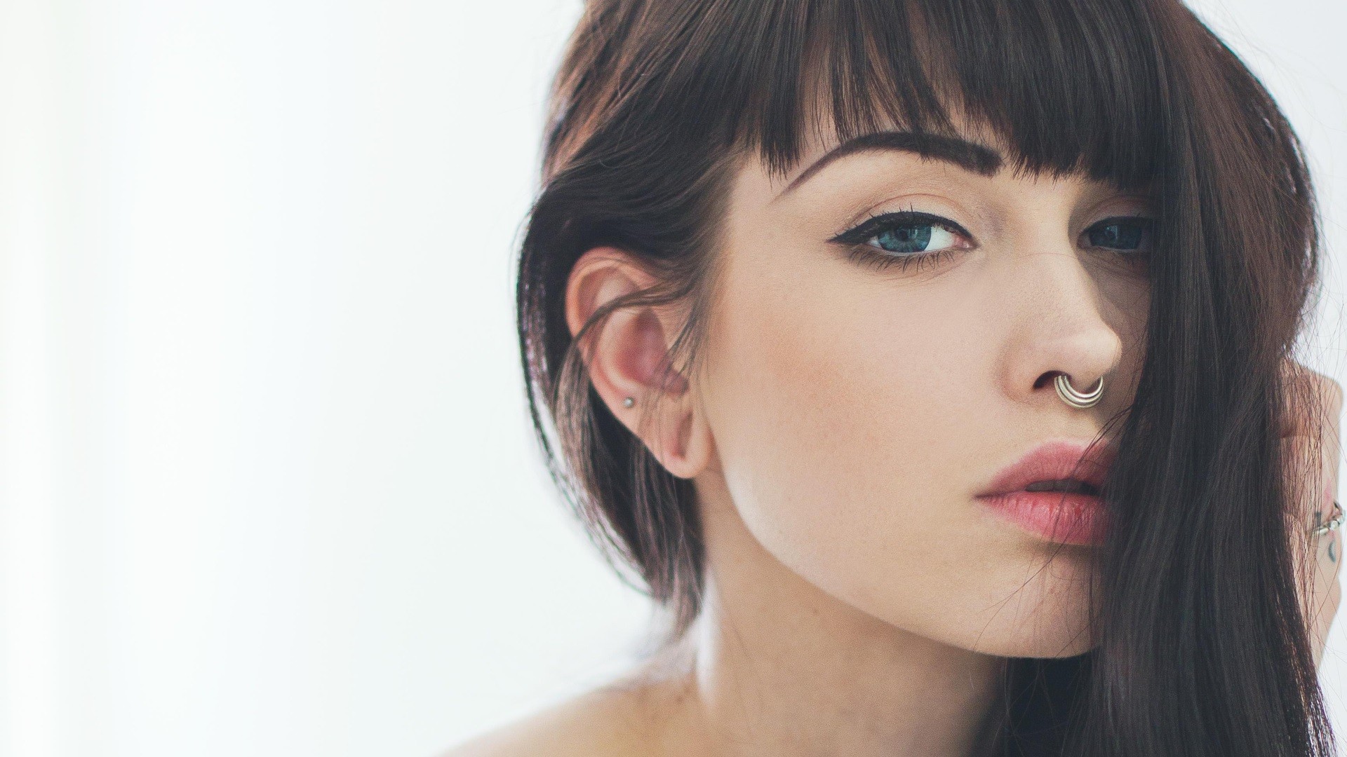 Woman with dark hair and septum piercing HD Wallpaper