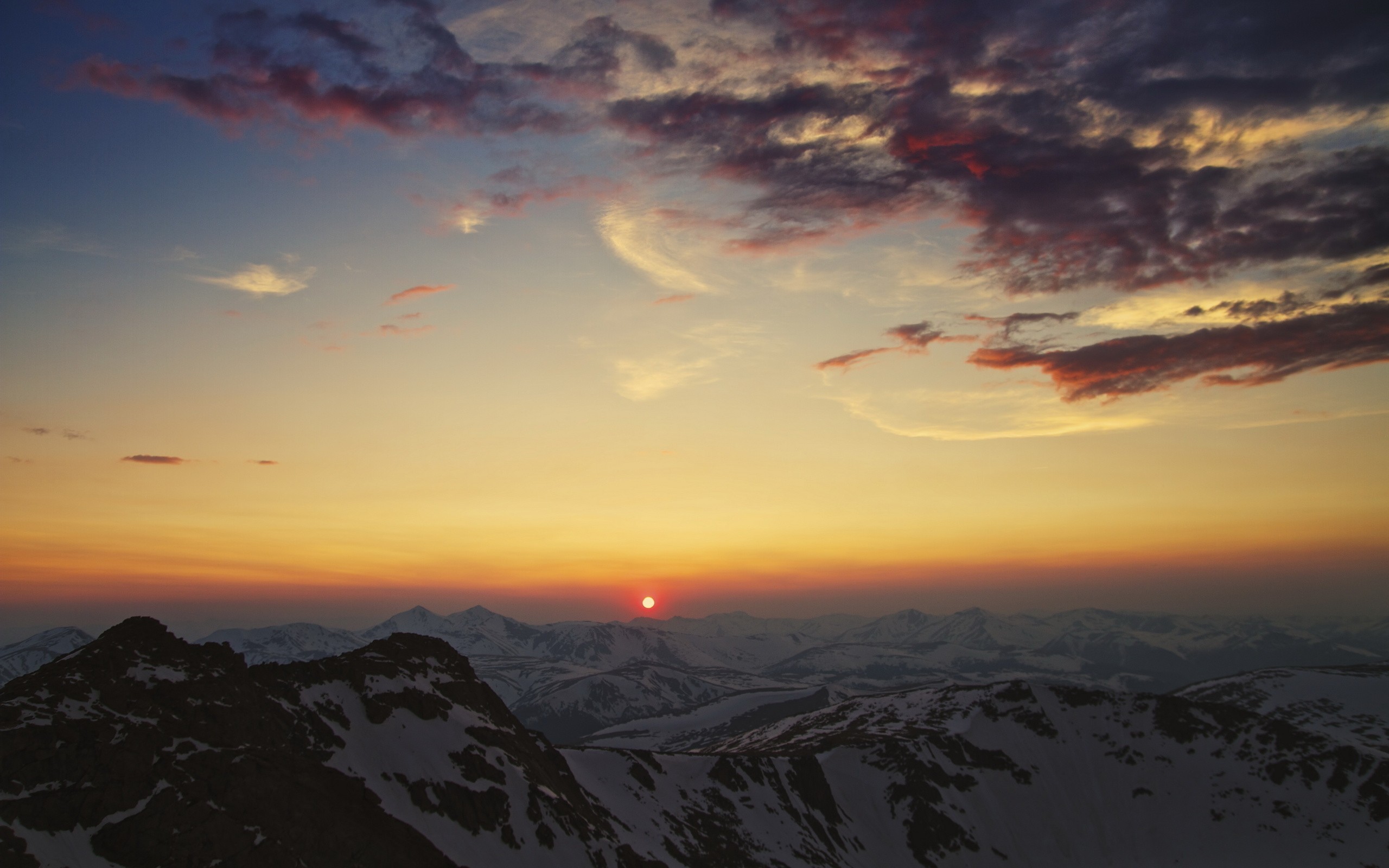 Sunset over snow-capped mountains HD Wallpaper