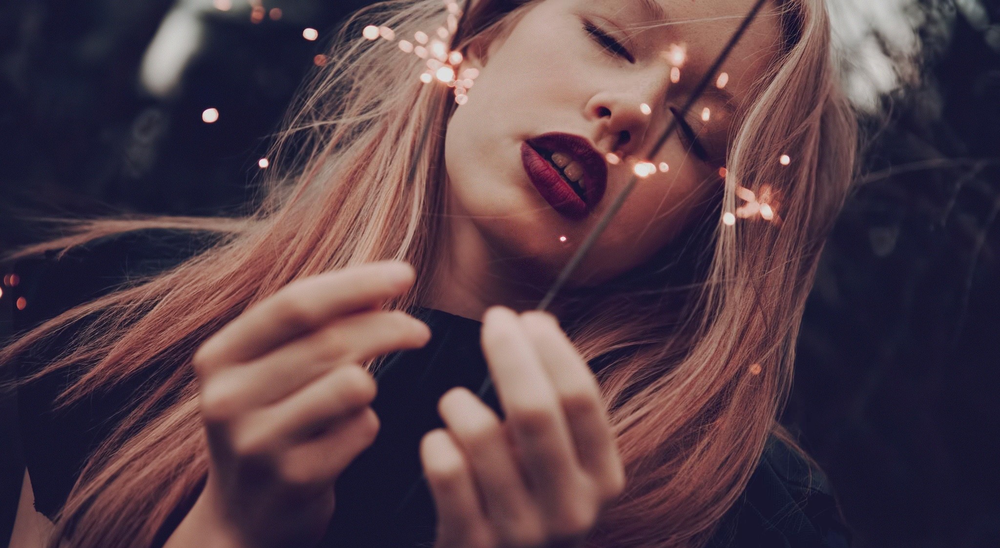 Woman with sparklers and red lipstick outdoors HD Wallpaper