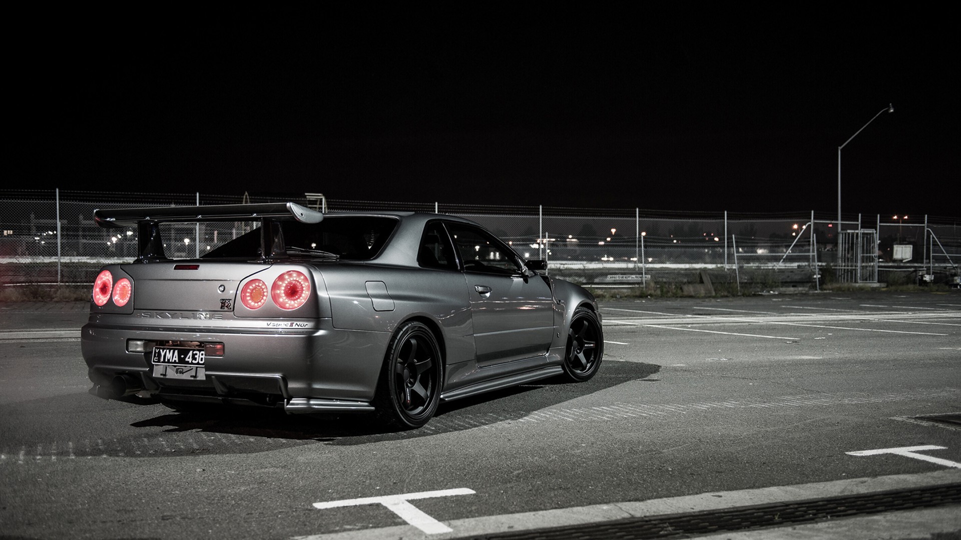 Nissan Skyline R34 GT-R parked at night HD Wallpaper