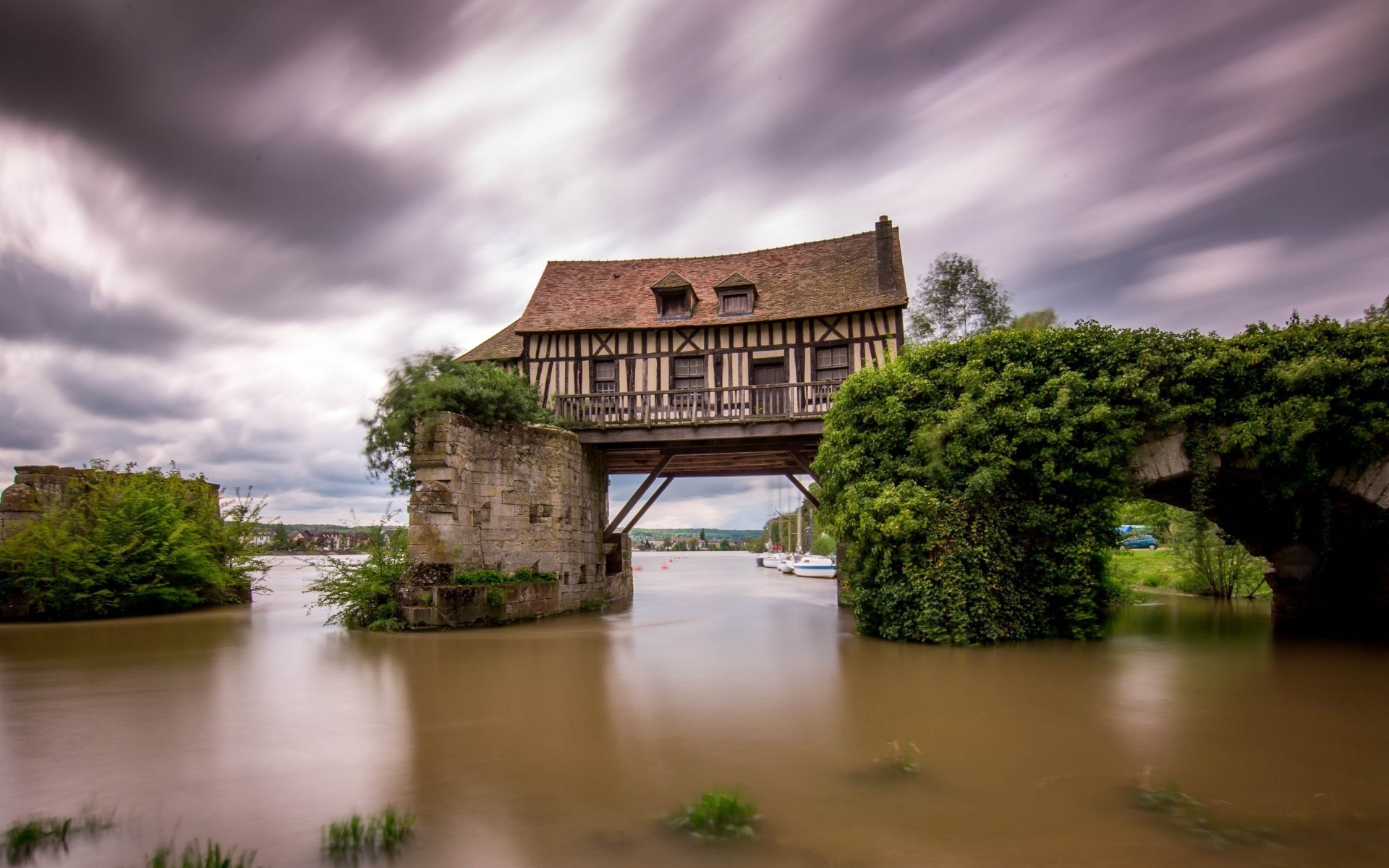 Half-timbered house on a bridge over water in France HD Wallpaper