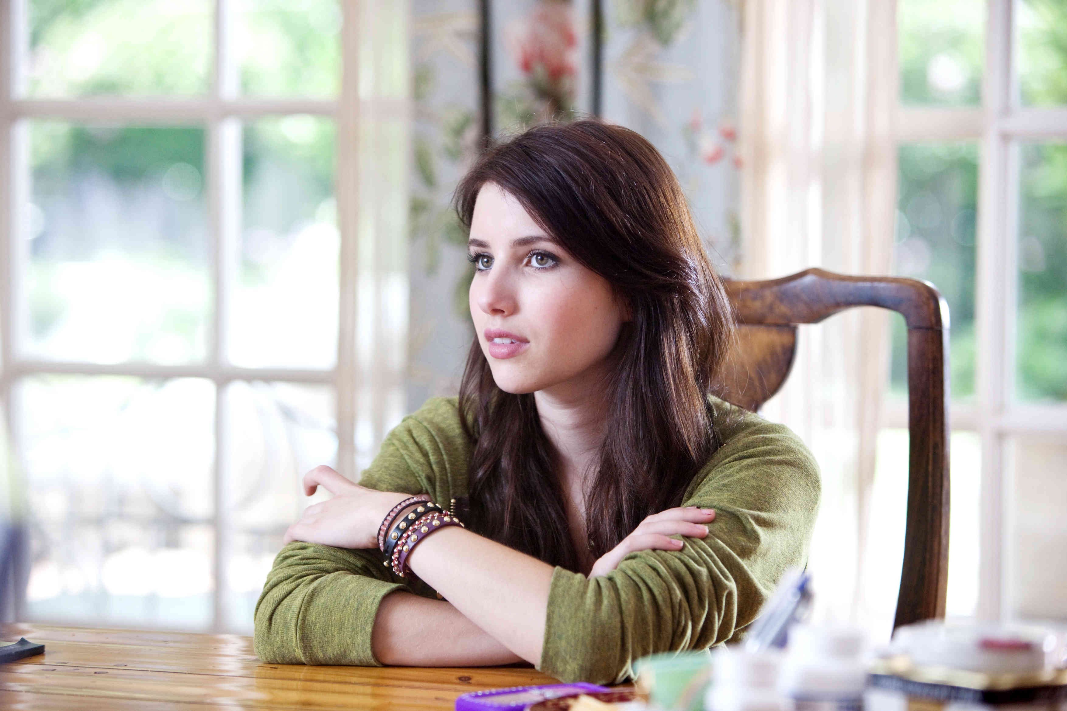 Emma Roberts sitting at a table HD Wallpaper