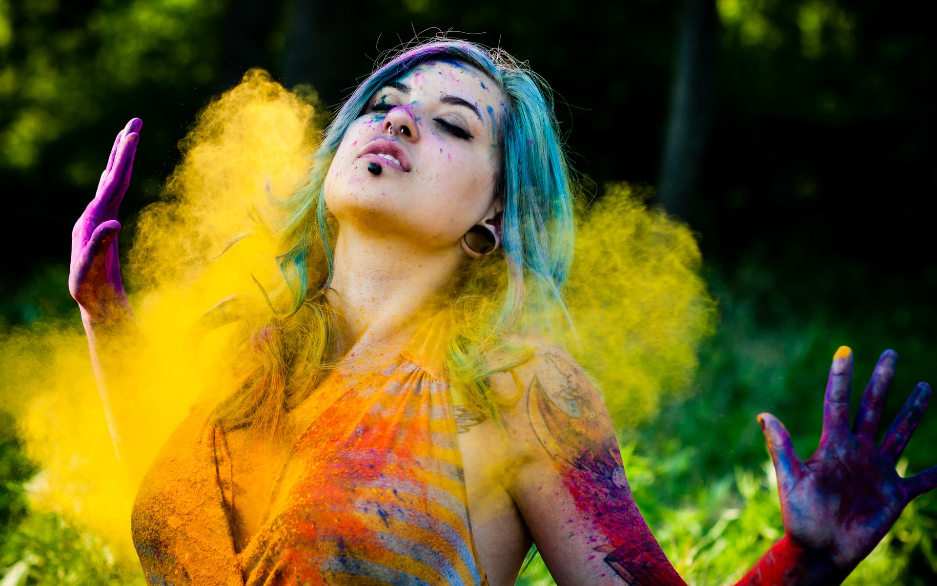 Woman covered in colorful powder with hands raised HD Wallpaper