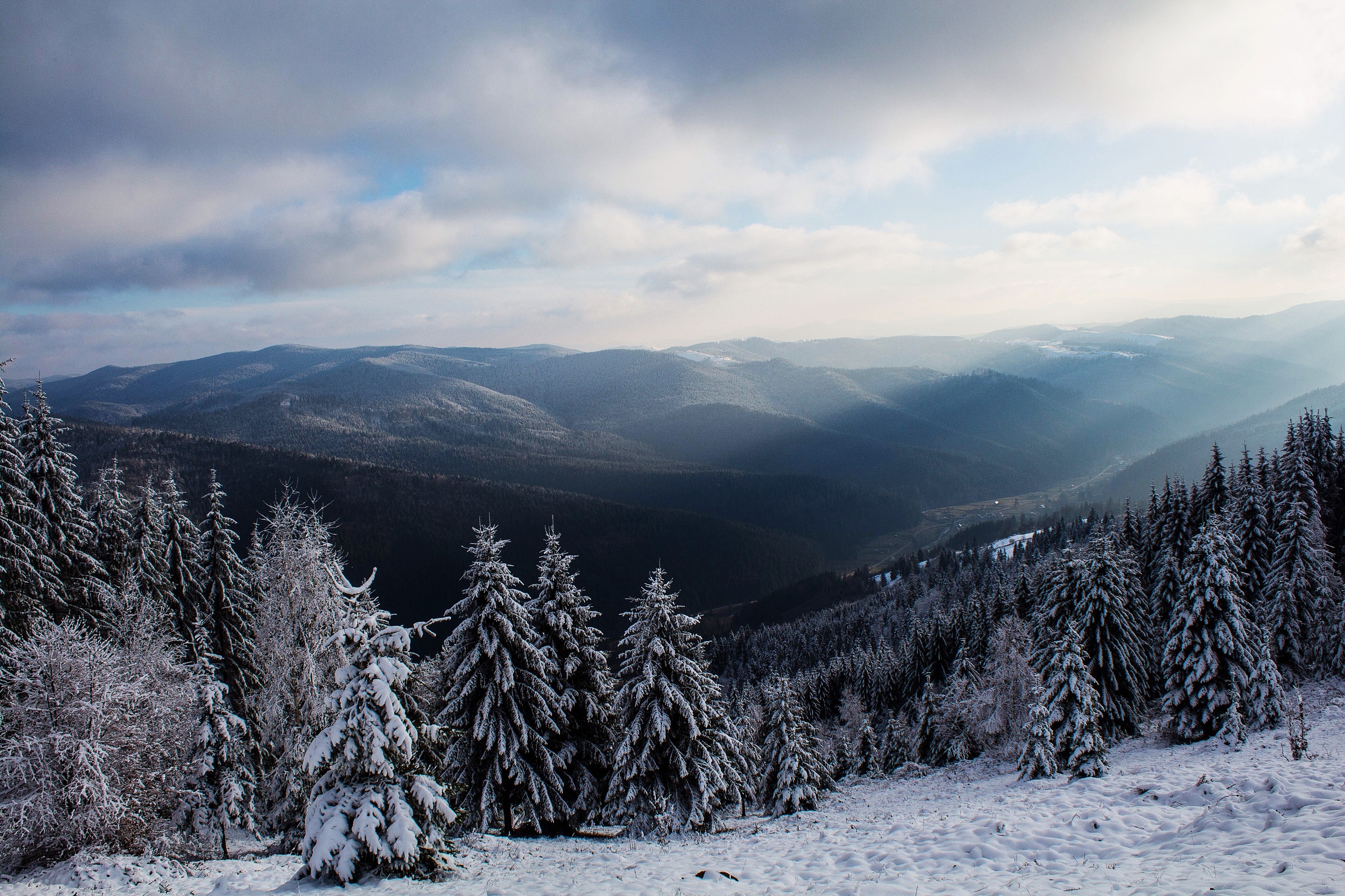Winter mountain landscape with sun rays through clouds HD Wallpaper