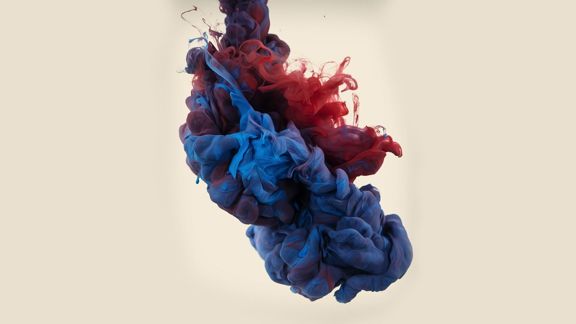 Red and blue paint swirling in water HD Wallpaper
