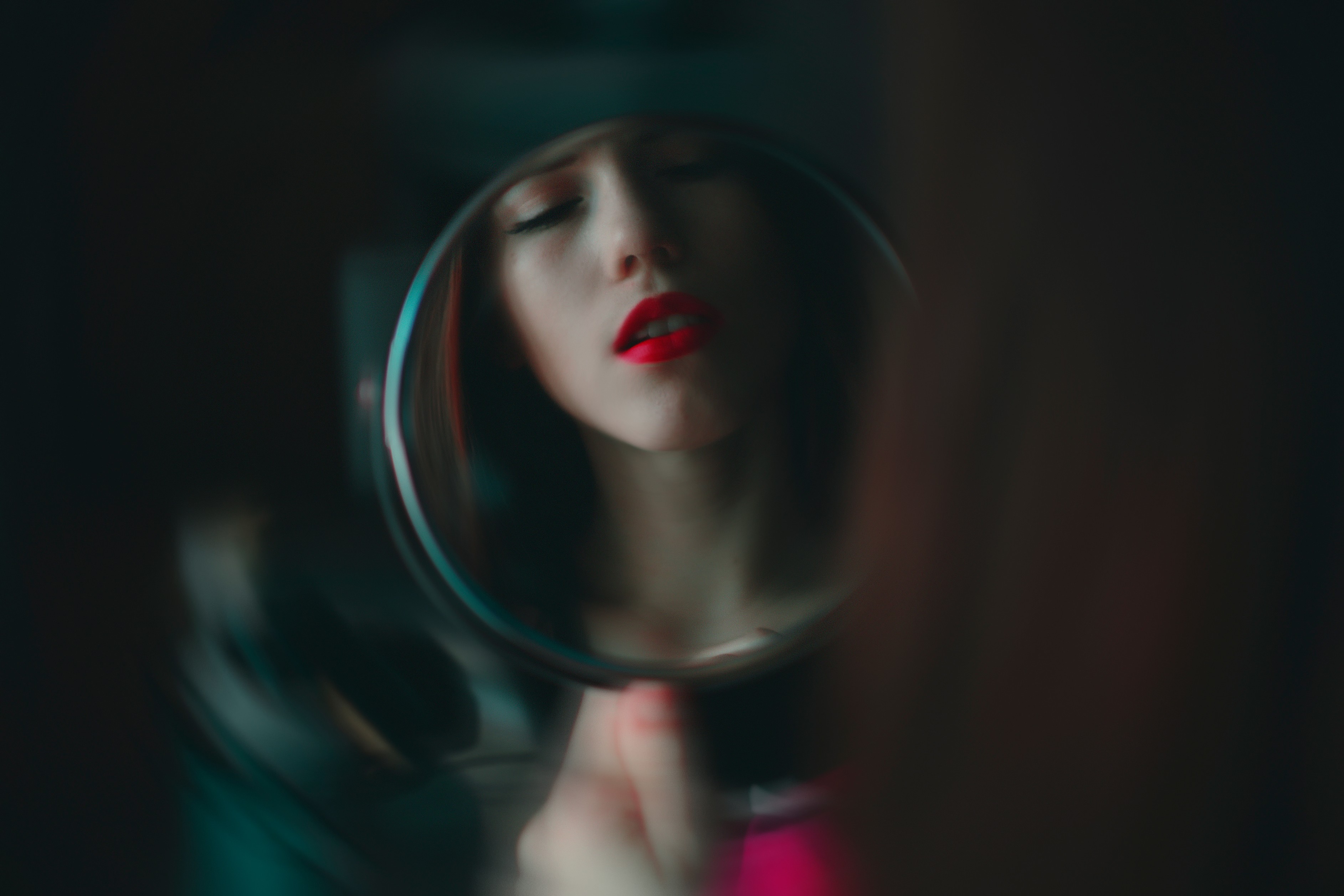Woman with red lipstick looking in a mirror HD Wallpaper