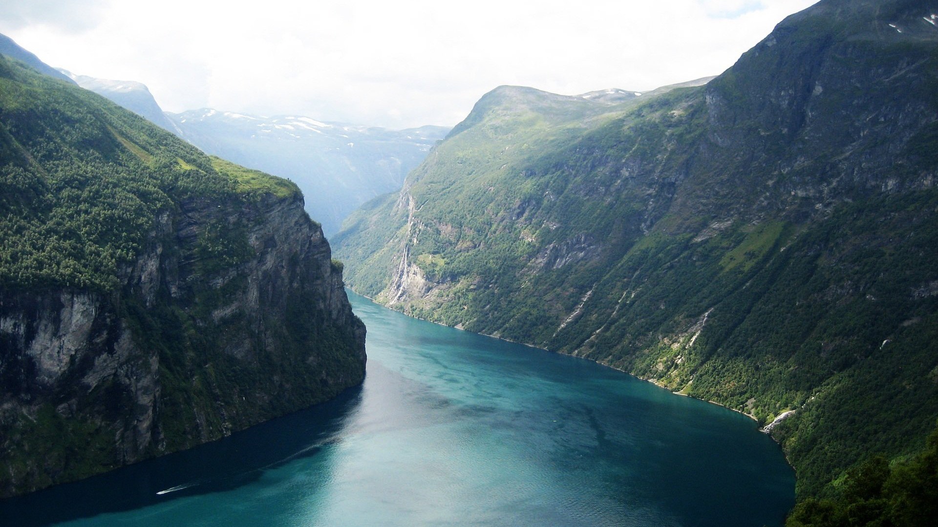 Geiranger Fjord in Norway with steep mountains and water HD Wallpaper