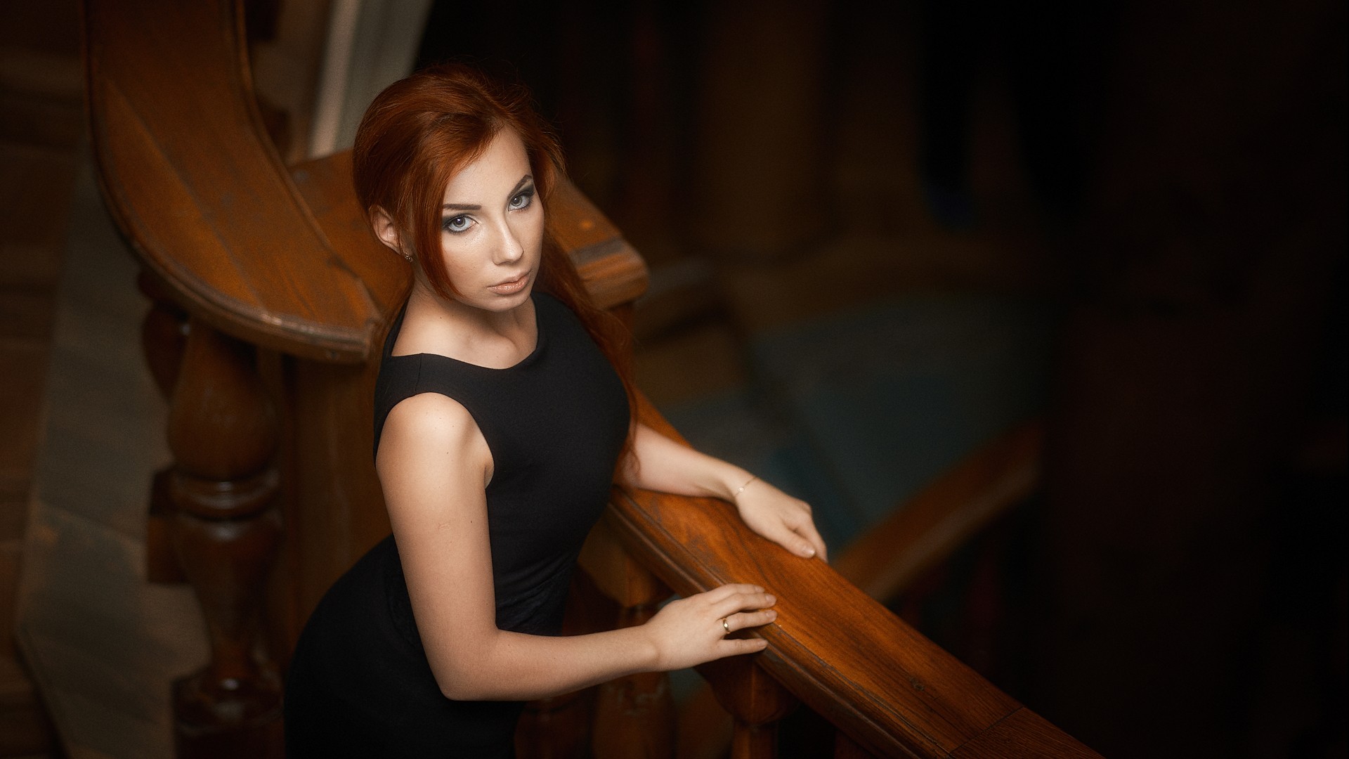 Redhead woman in a black dress on a wooden staircase HD Wallpaper