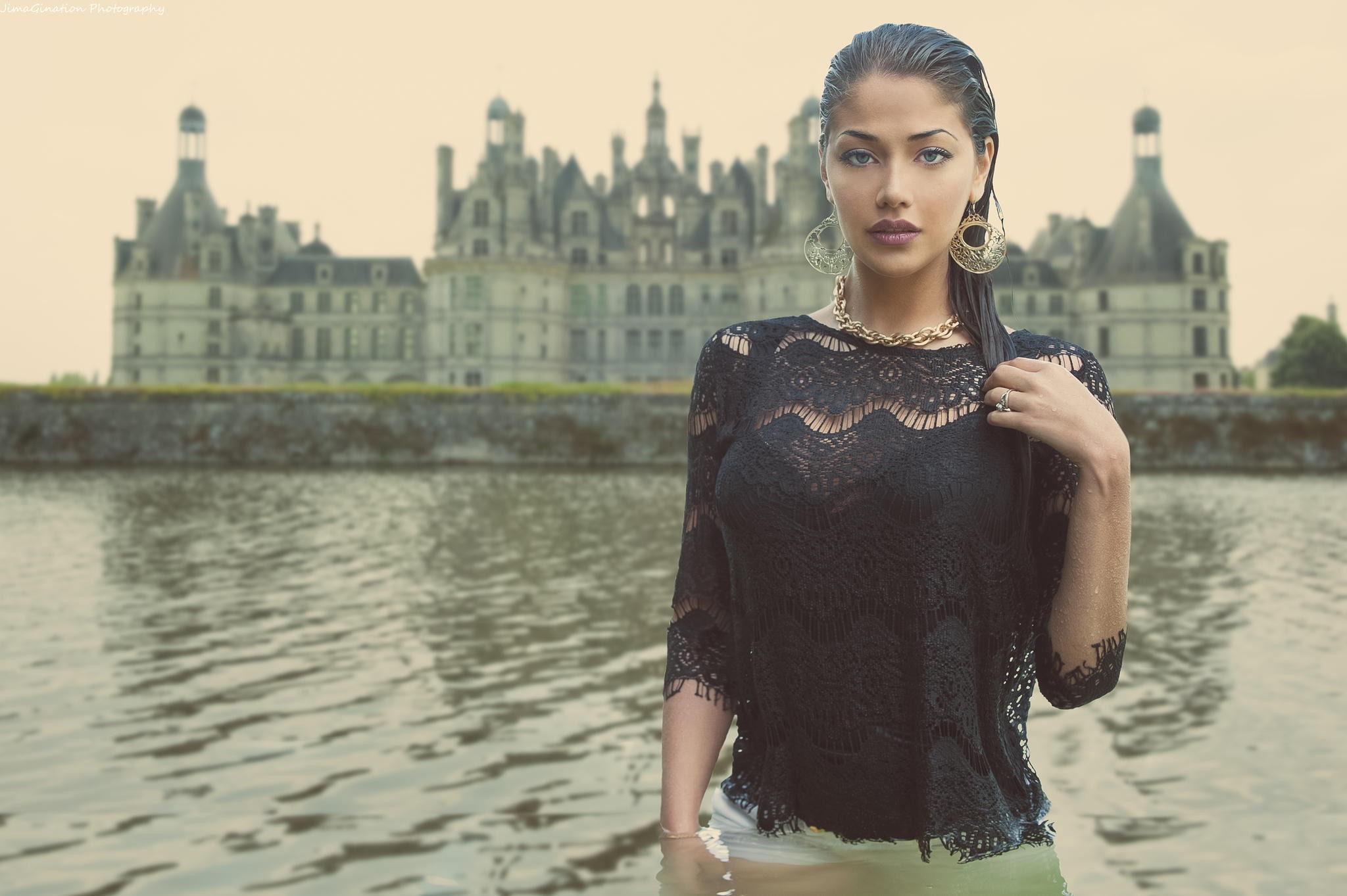 Woman in black lace top in water with castle background HD Wallpaper