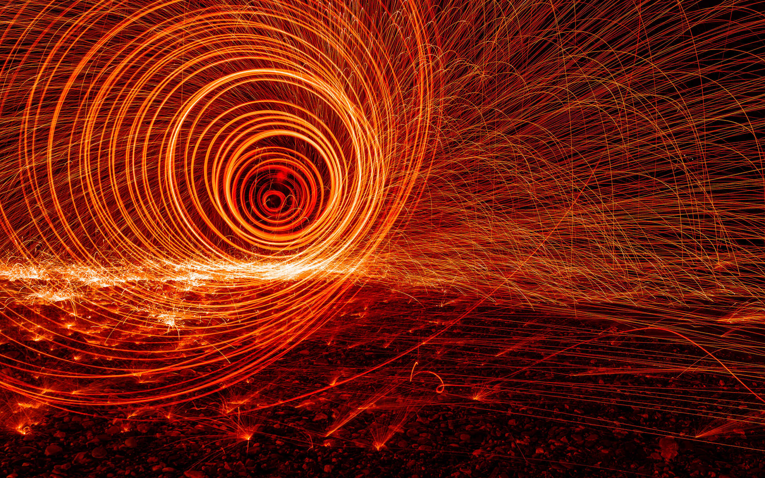 Light painting with sparks in a spiral pattern HD Wallpaper