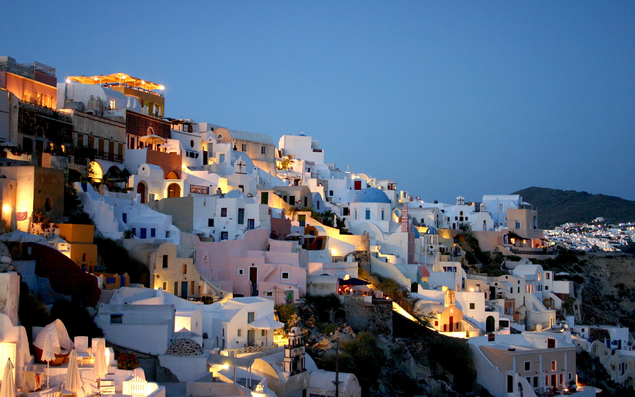 Santorini cityscape at dusk with white buildings HD Wallpaper