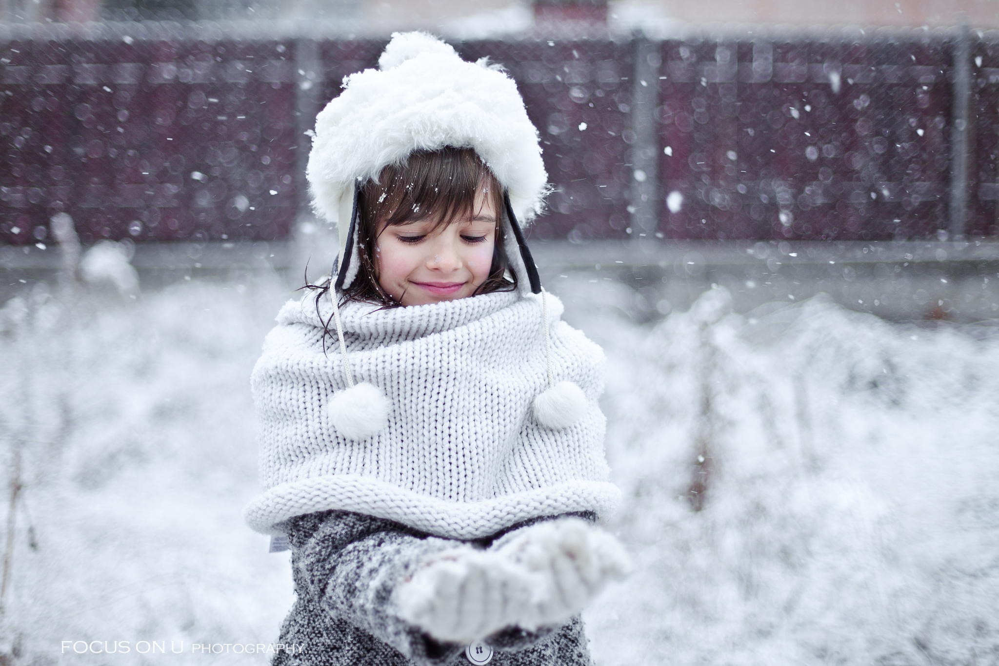 Young girl in winter hat and scarf playing in snow HD Wallpaper