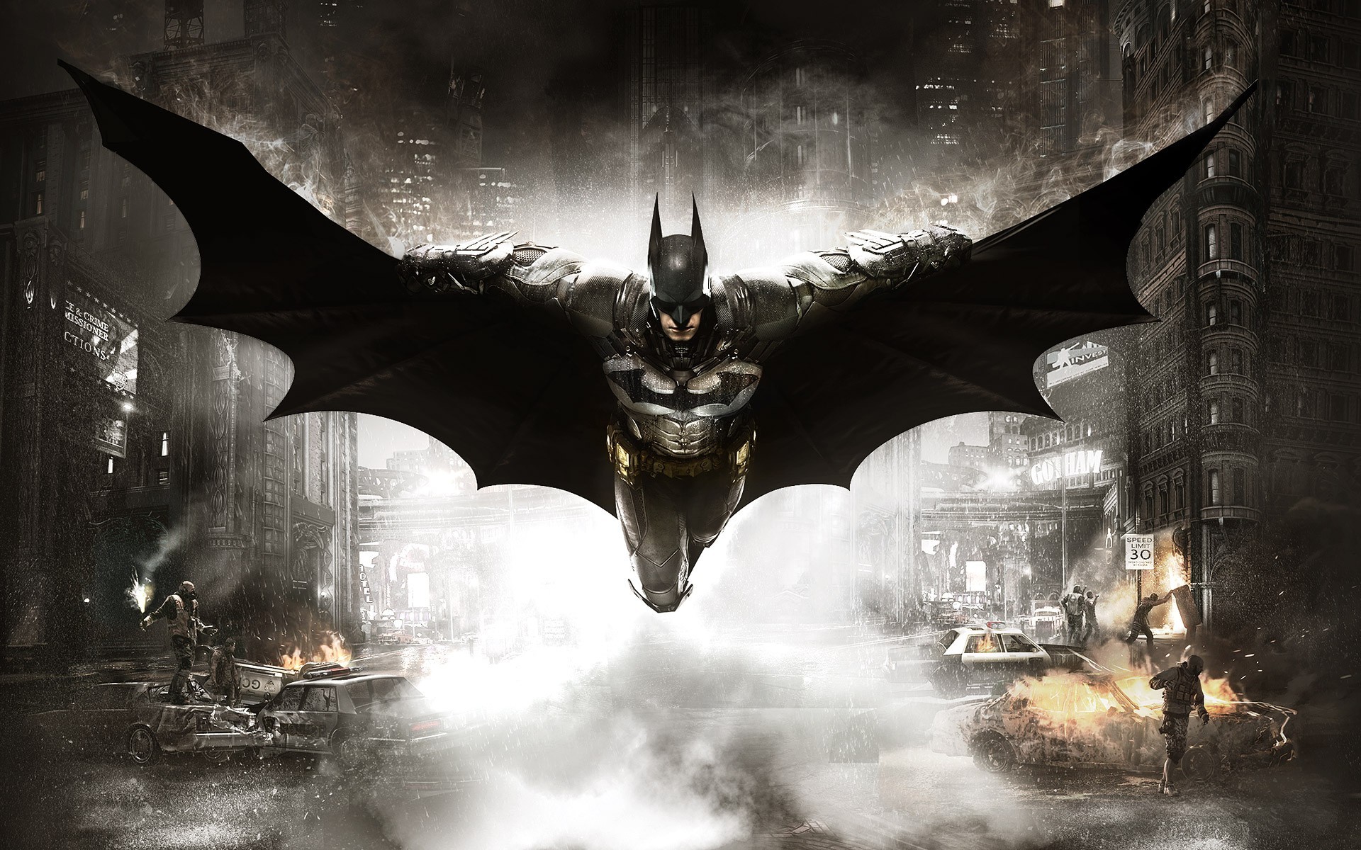 Batman flying over a burning Gotham City street HD Wallpaper
