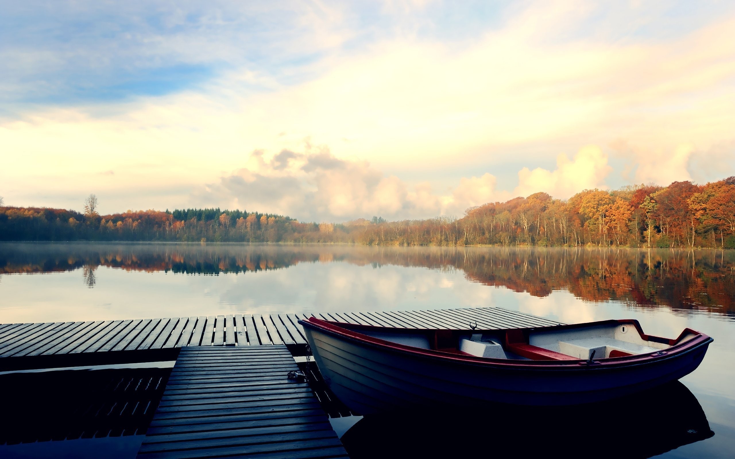 Boat docked at a pier on a lake during fall HD Wallpaper