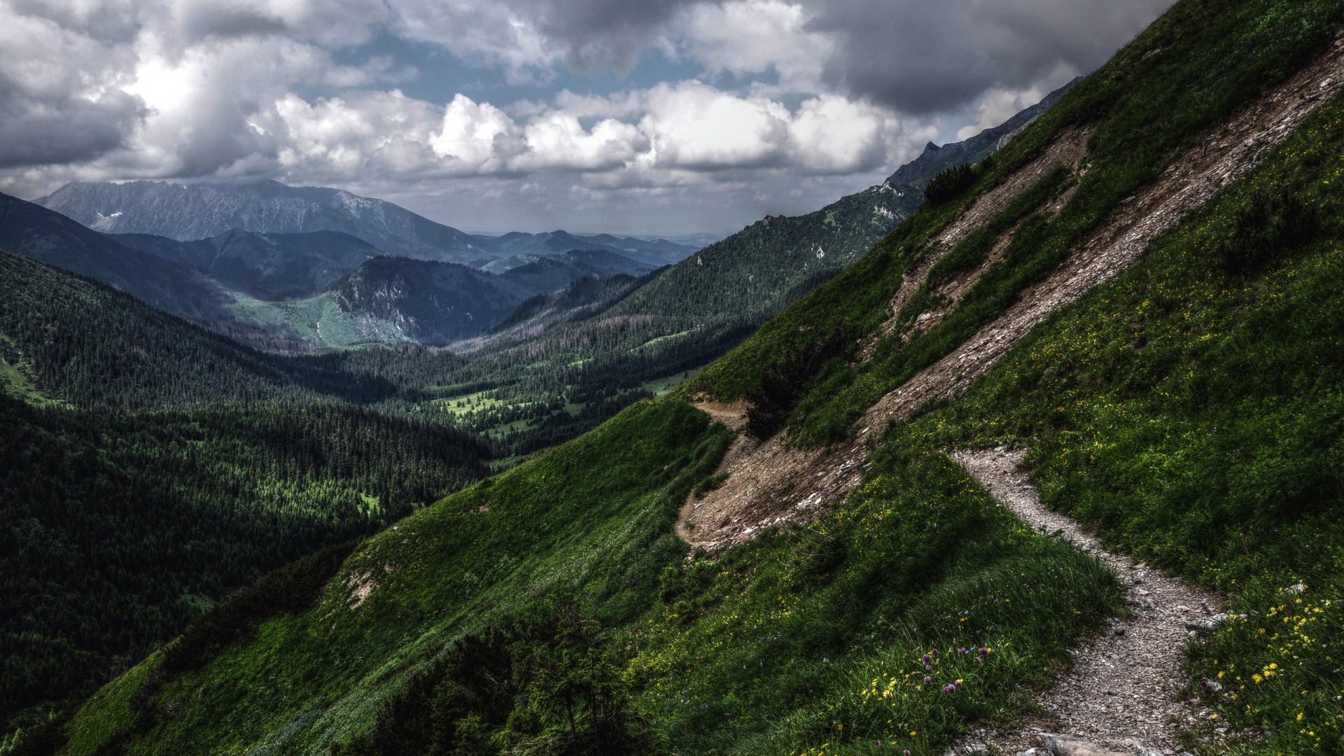 Mountain landscape with clouds and a hiking trail HD Wallpaper