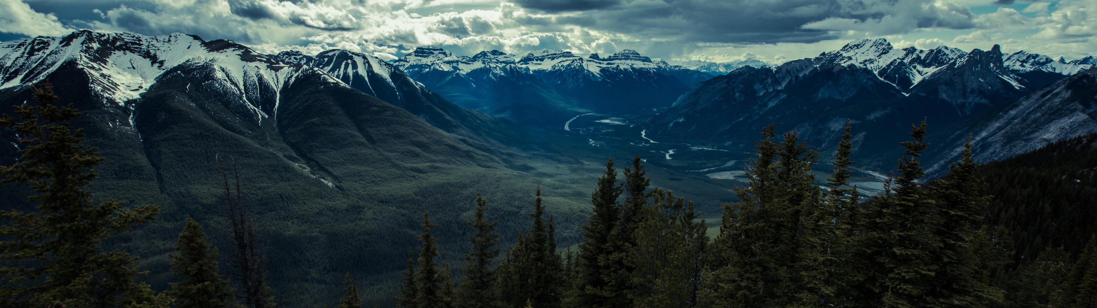 Panoramic view of snow-capped mountains and a valley HD Wallpaper