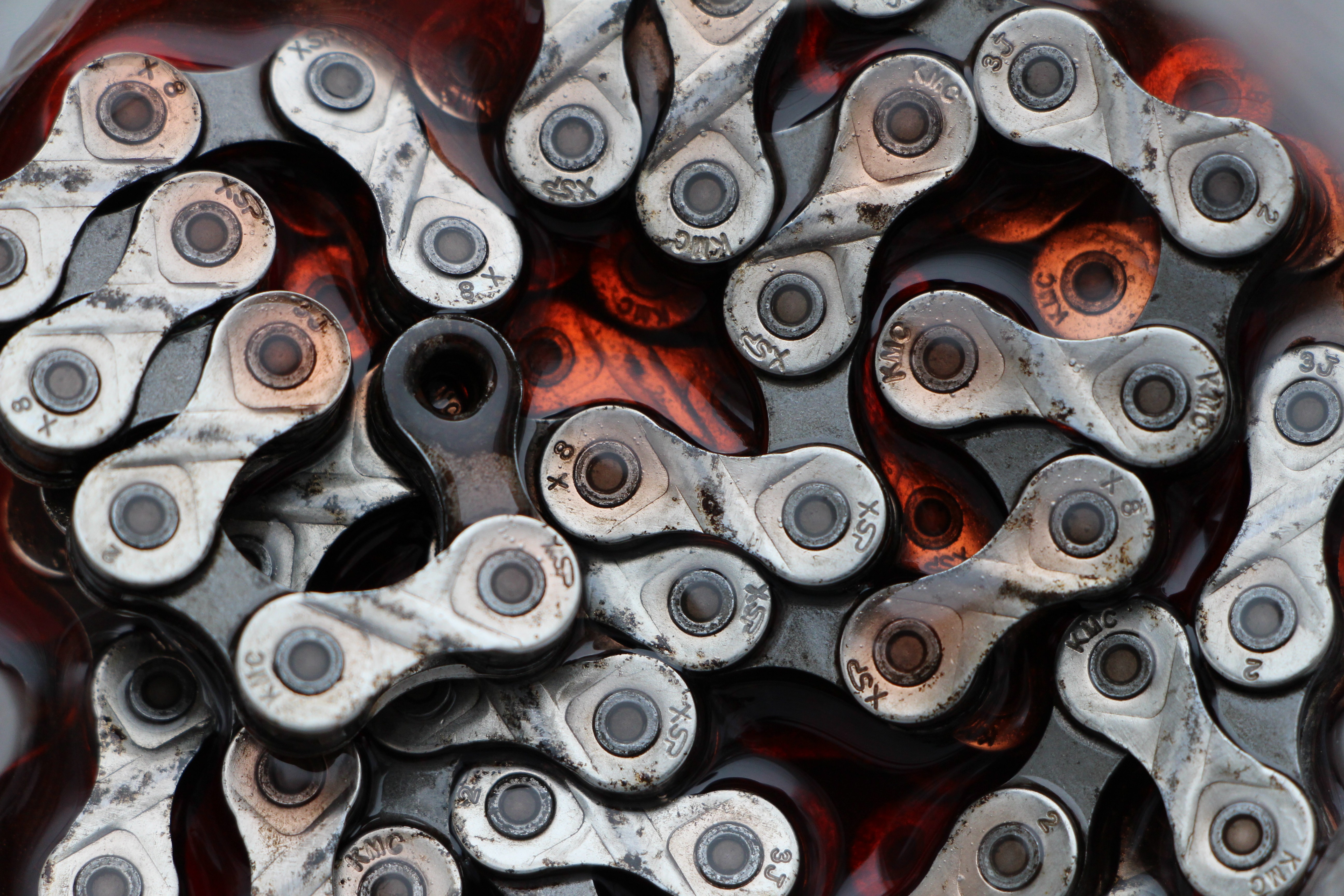 KMC Bicycle Chain Macro Shot in Red Liquid HD Wallpaper