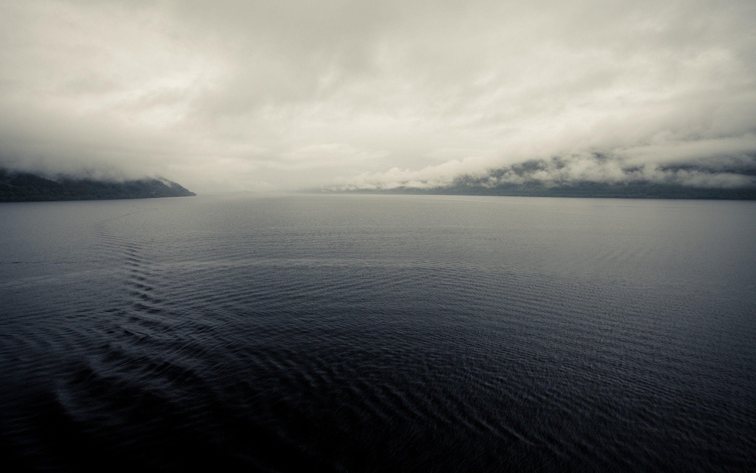 Misty lake with forested shores and cloudy sky HD Wallpaper
