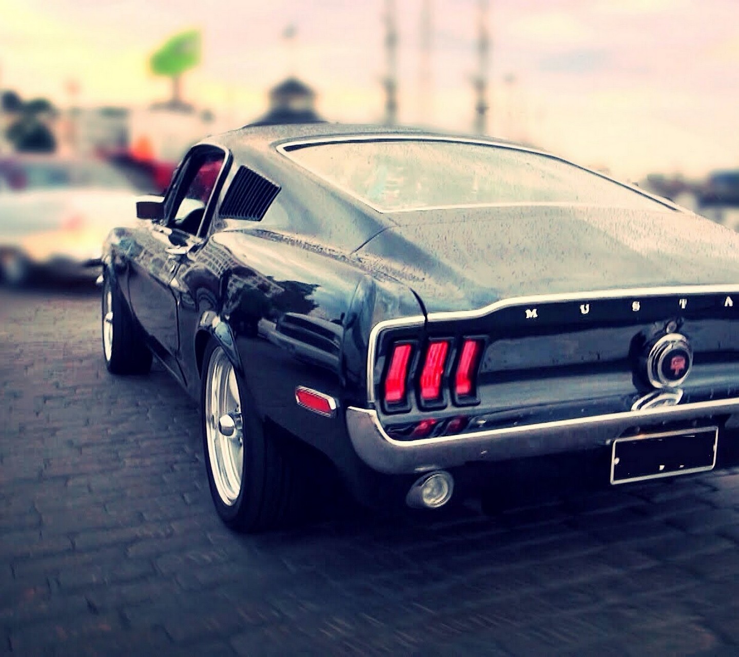 Black Ford Mustang parked on a cobblestone street HD Wallpaper