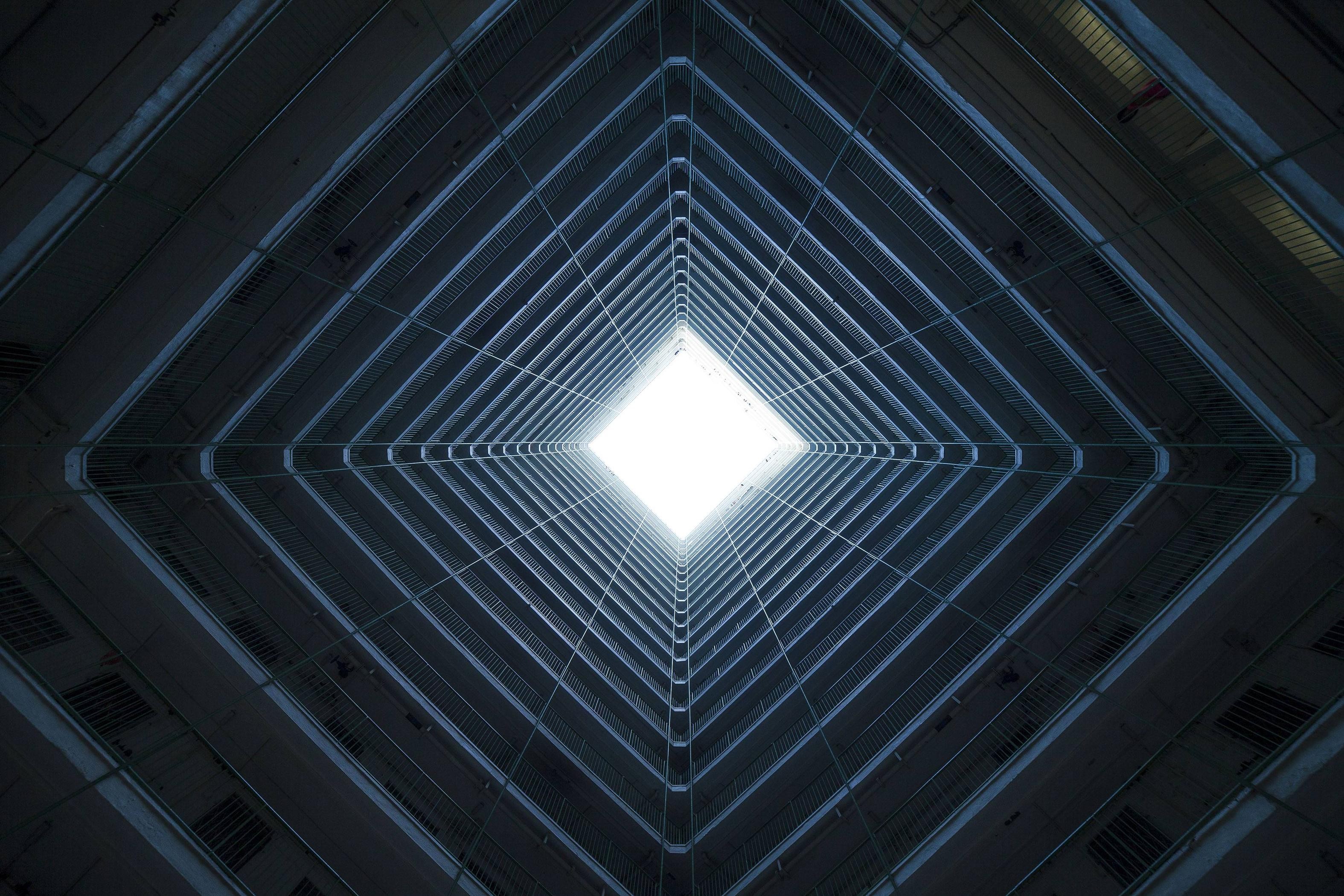 Symmetrical building interior looking up at the sky HD Wallpaper