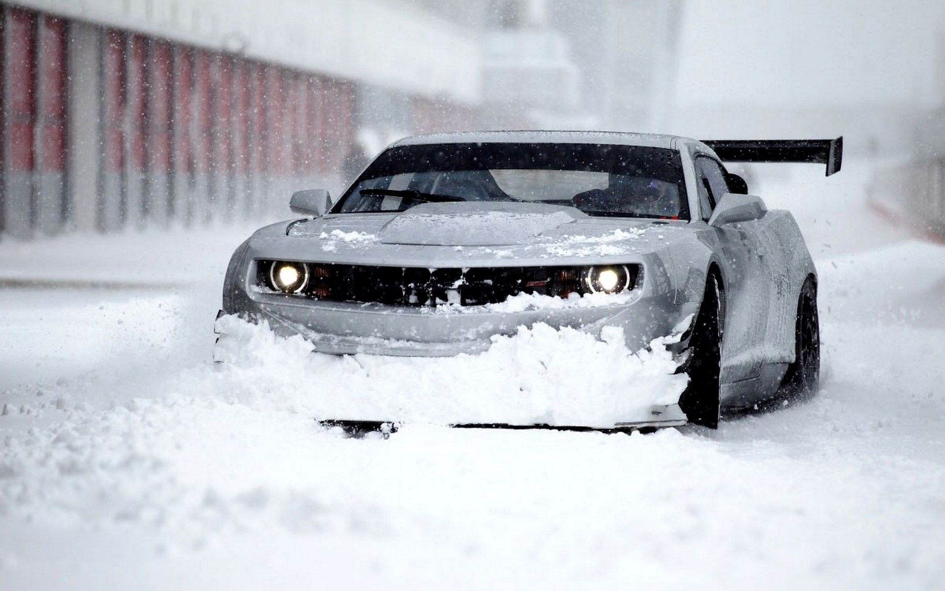 Silver Chevrolet Camaro driving through snow HD Wallpaper