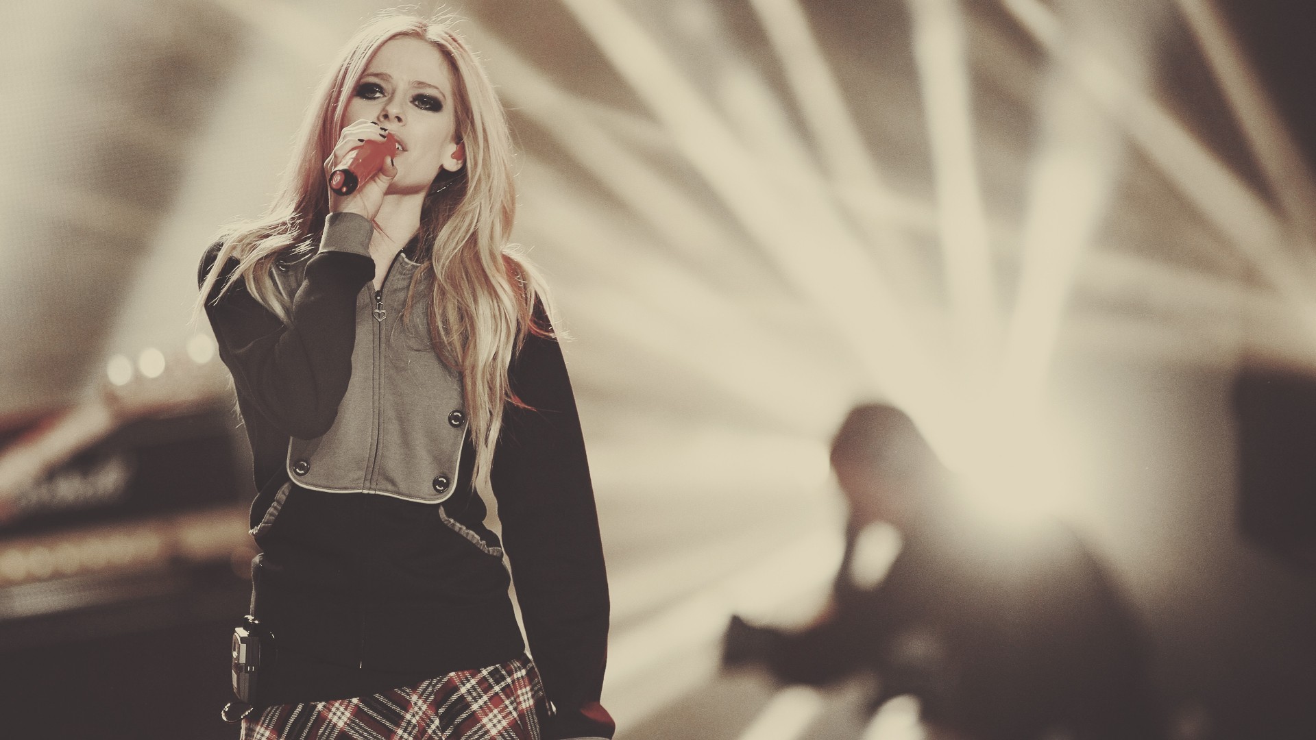 Avril Lavigne singing on stage with bright lights HD Wallpaper