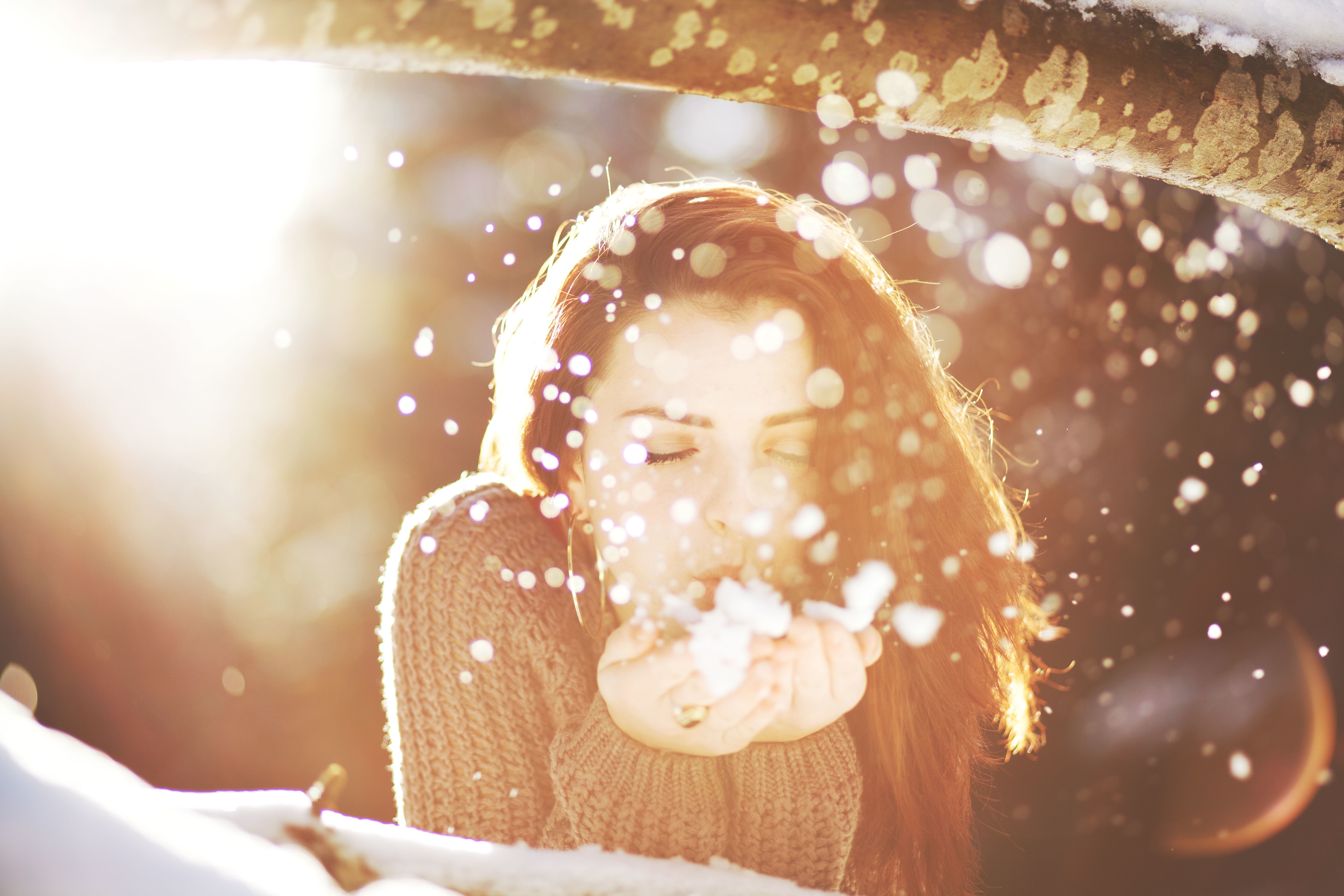 Woman blowing snow in bright sunlight HD Wallpaper