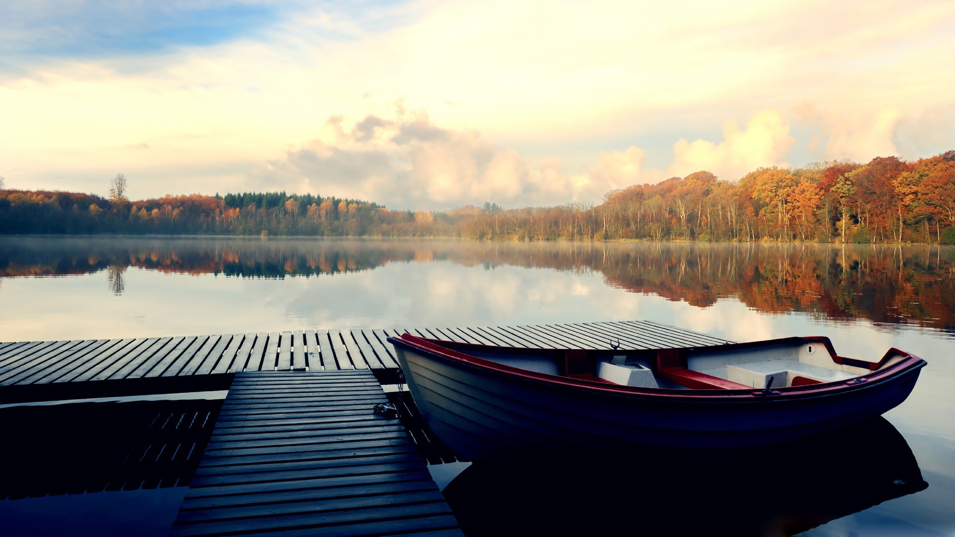 Boat docked at a pier on a lake during fall HD Wallpaper