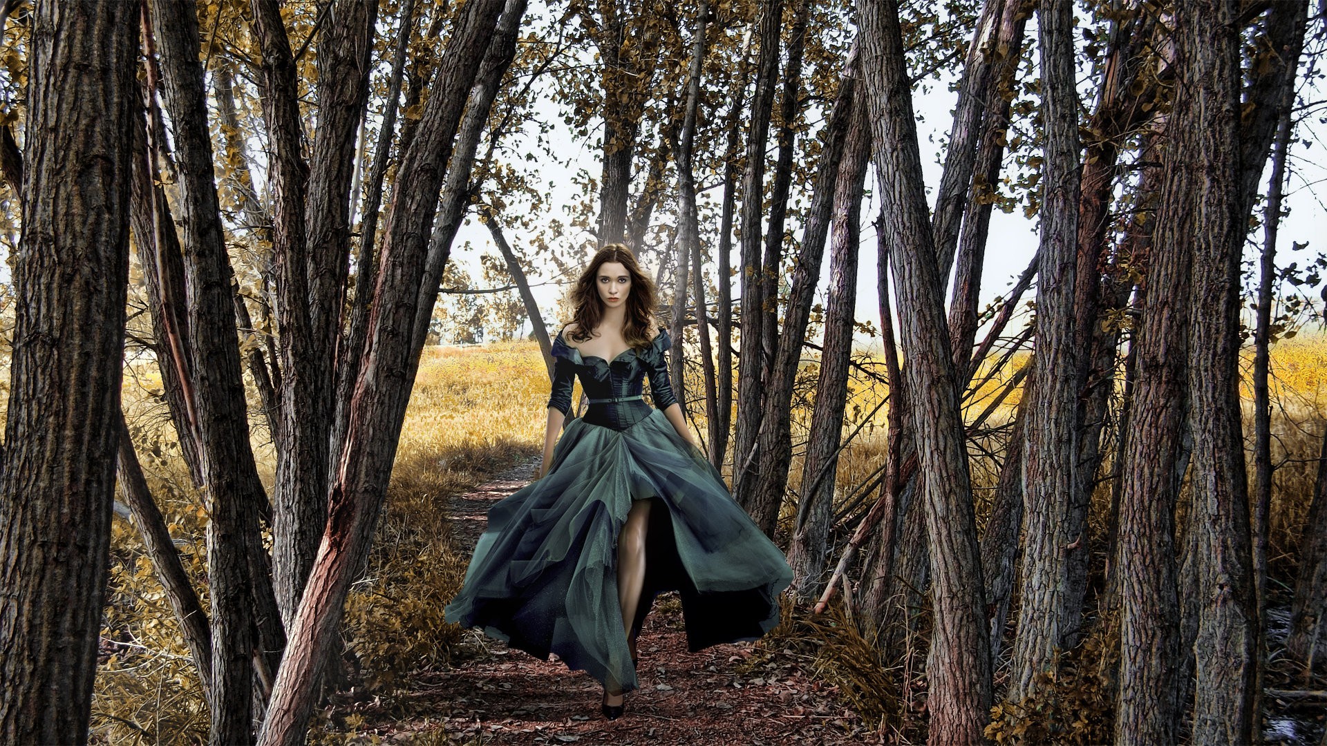 Woman in a dark dress walking in a forest HD Wallpaper