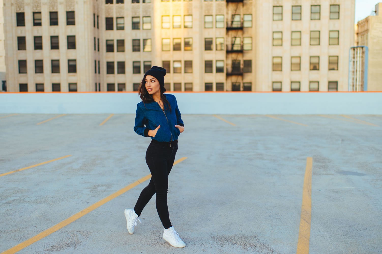 Woman in blue jacket and black pants on rooftop HD Wallpaper