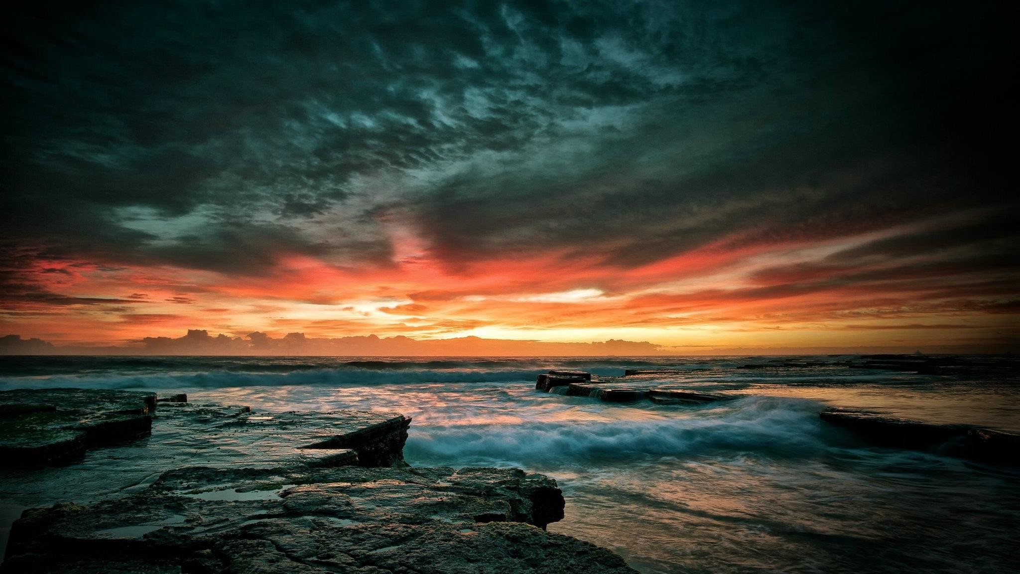 Ocean sunset with dramatic clouds and rocks HD Wallpaper