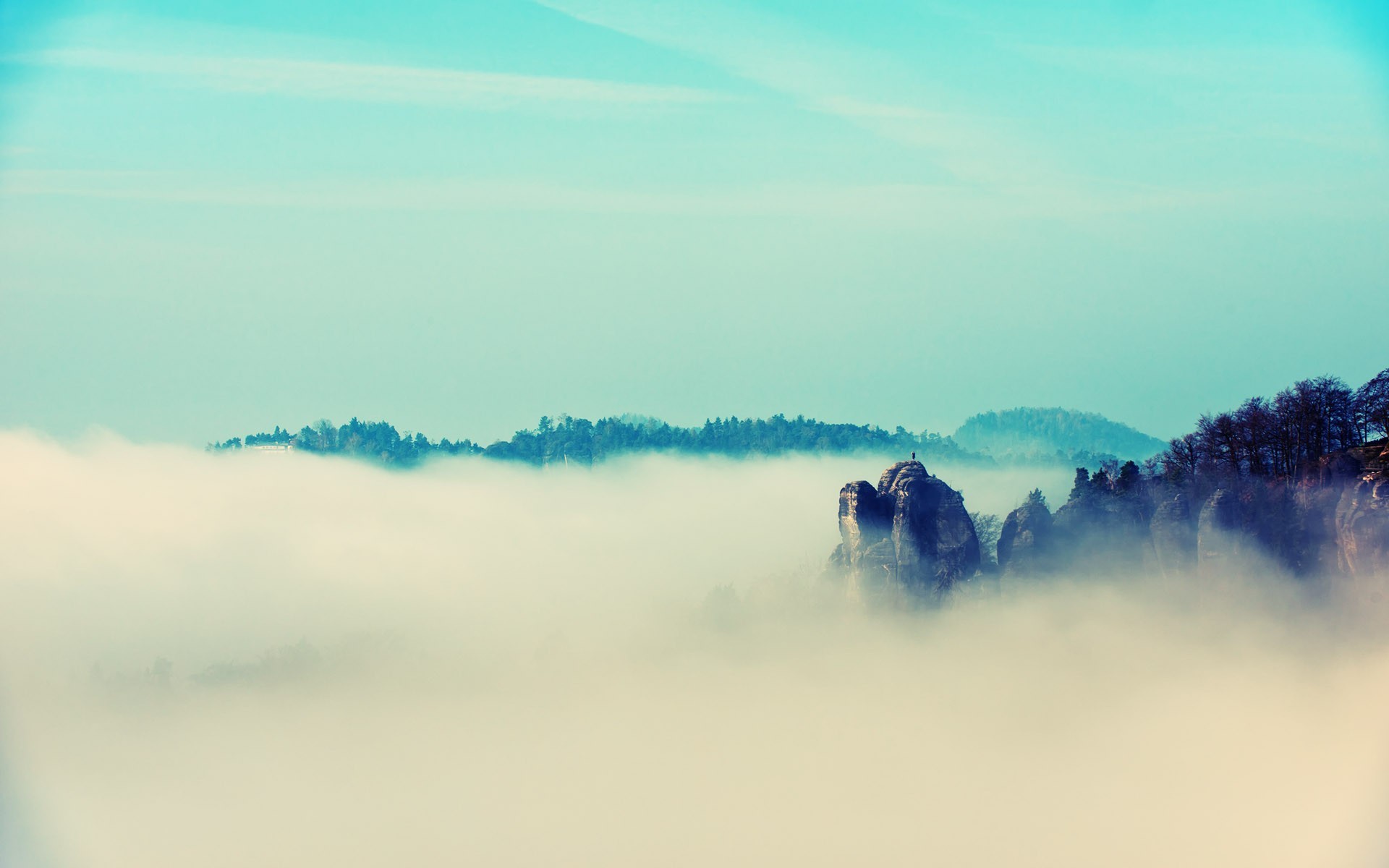 Misty mountains landscape with rock formations HD Wallpaper