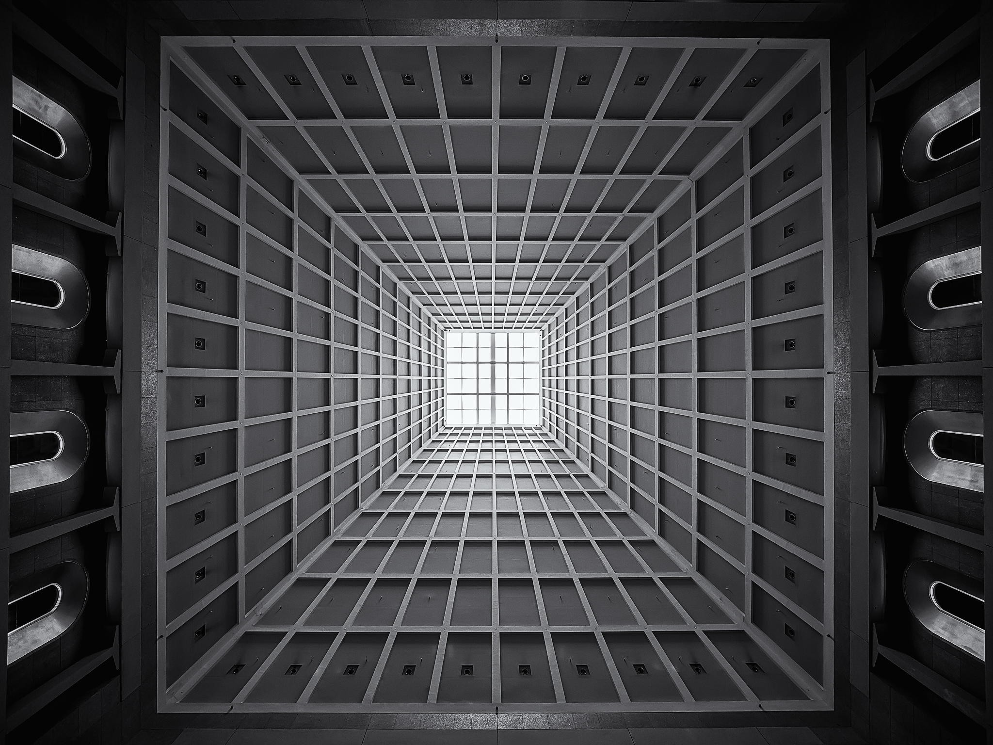 Monochrome building interior with geometric ceiling and skylight HD Wallpaper