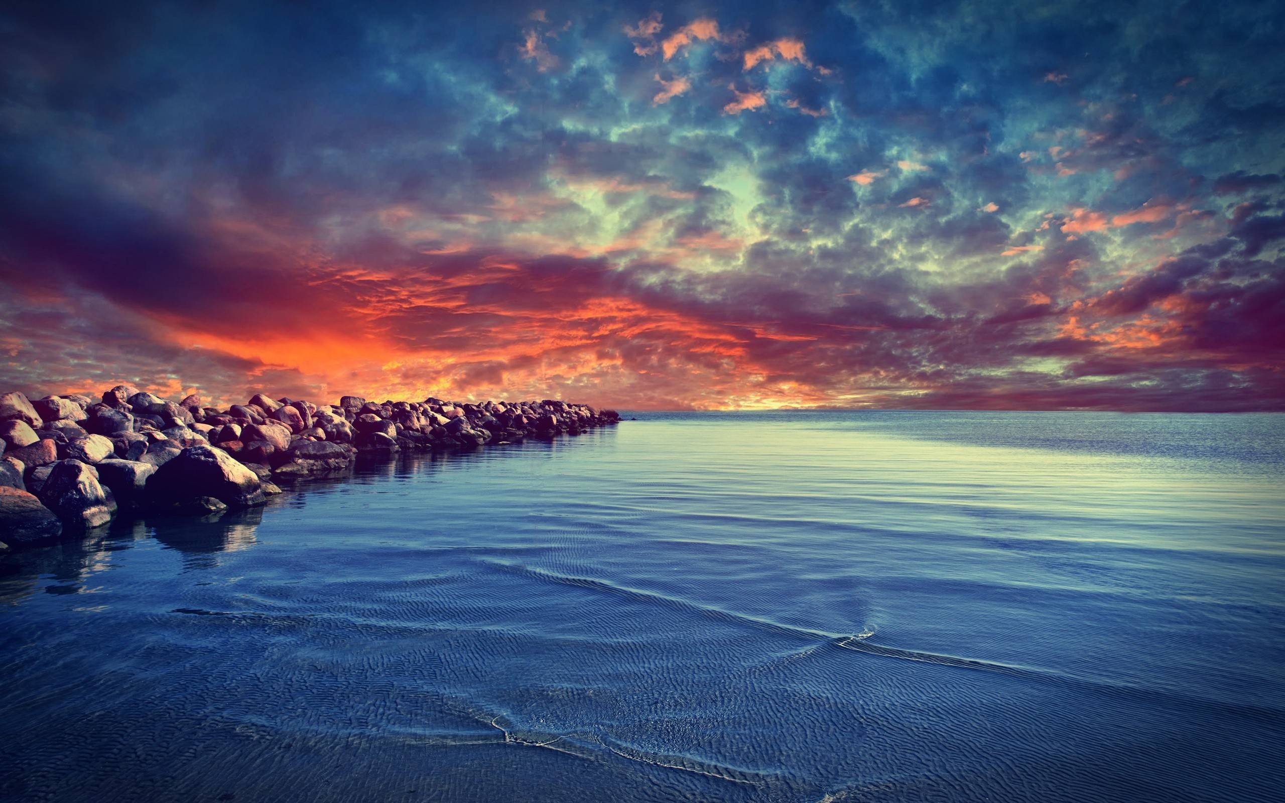 Colorful sunset over the sea with a rocky coast HD Wallpaper