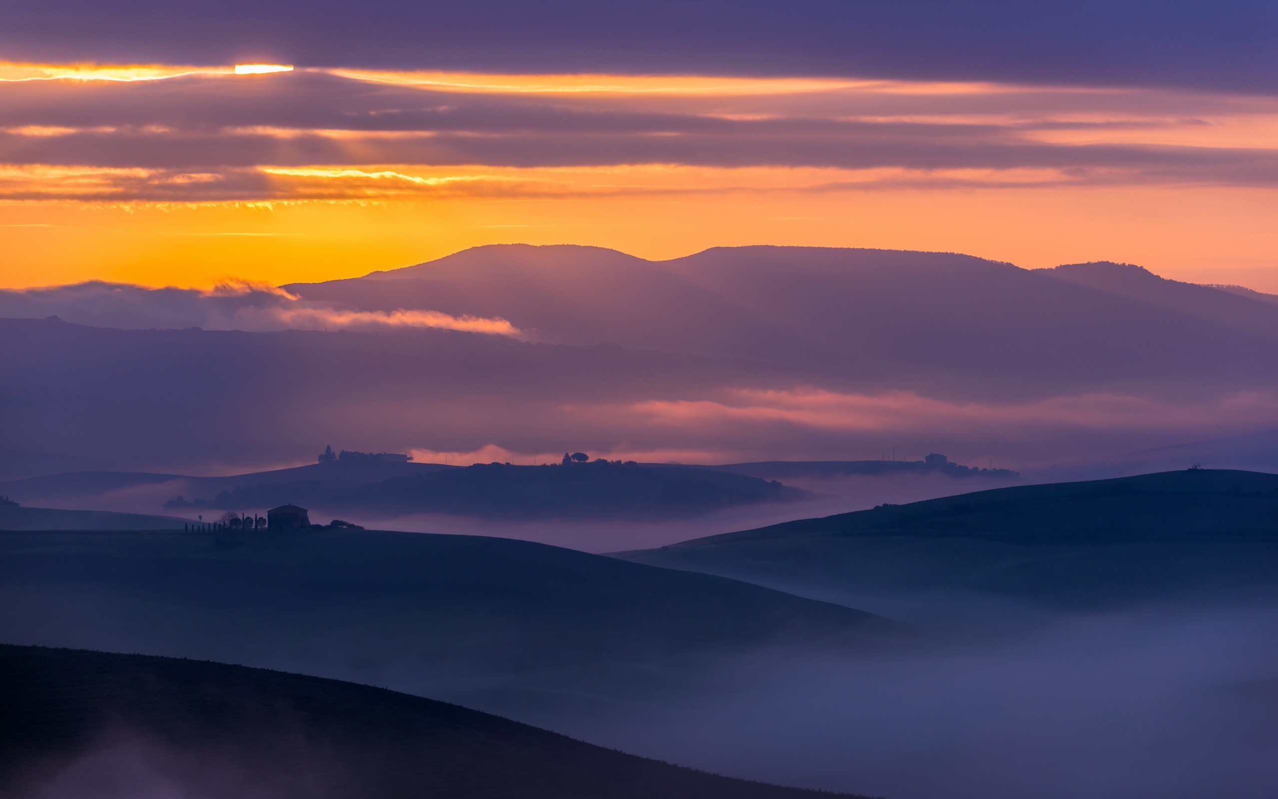 Tuscan landscape at sunset with rolling hills and mist HD Wallpaper