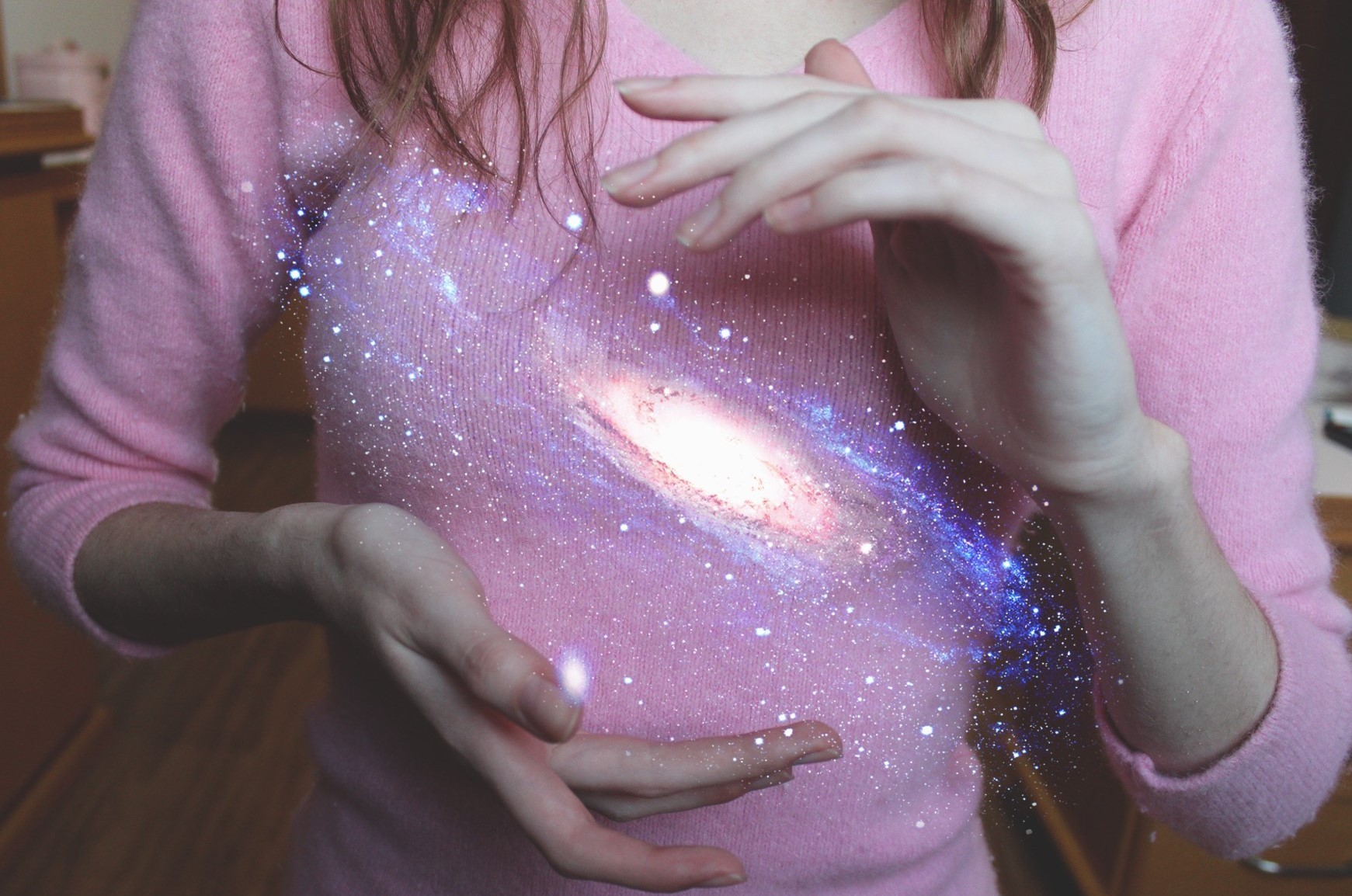 Woman holding a galaxy between her hands HD Wallpaper