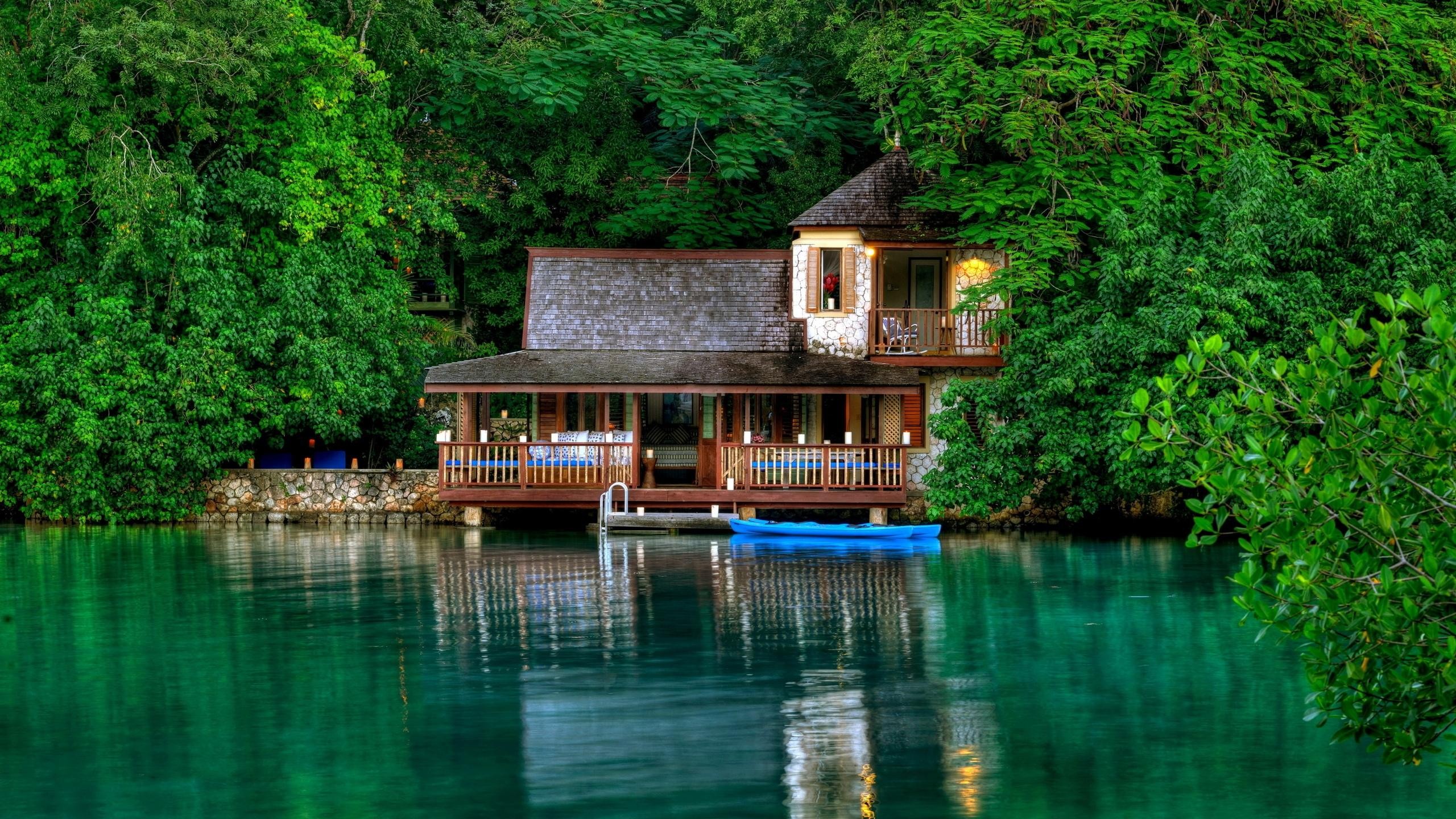 House on the water surrounded by trees HD Wallpaper