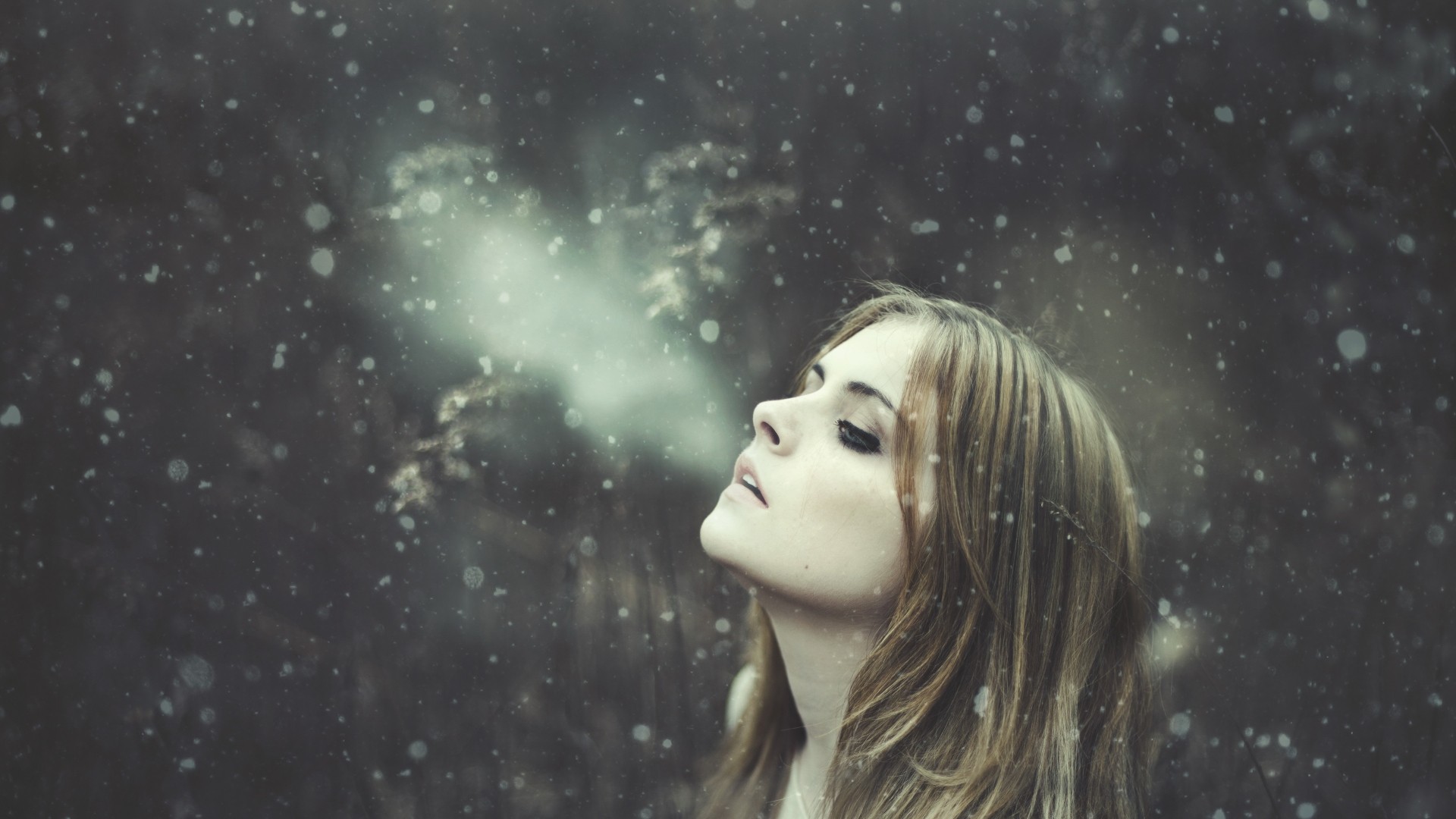 Woman exhaling steam in the snow HD Wallpaper
