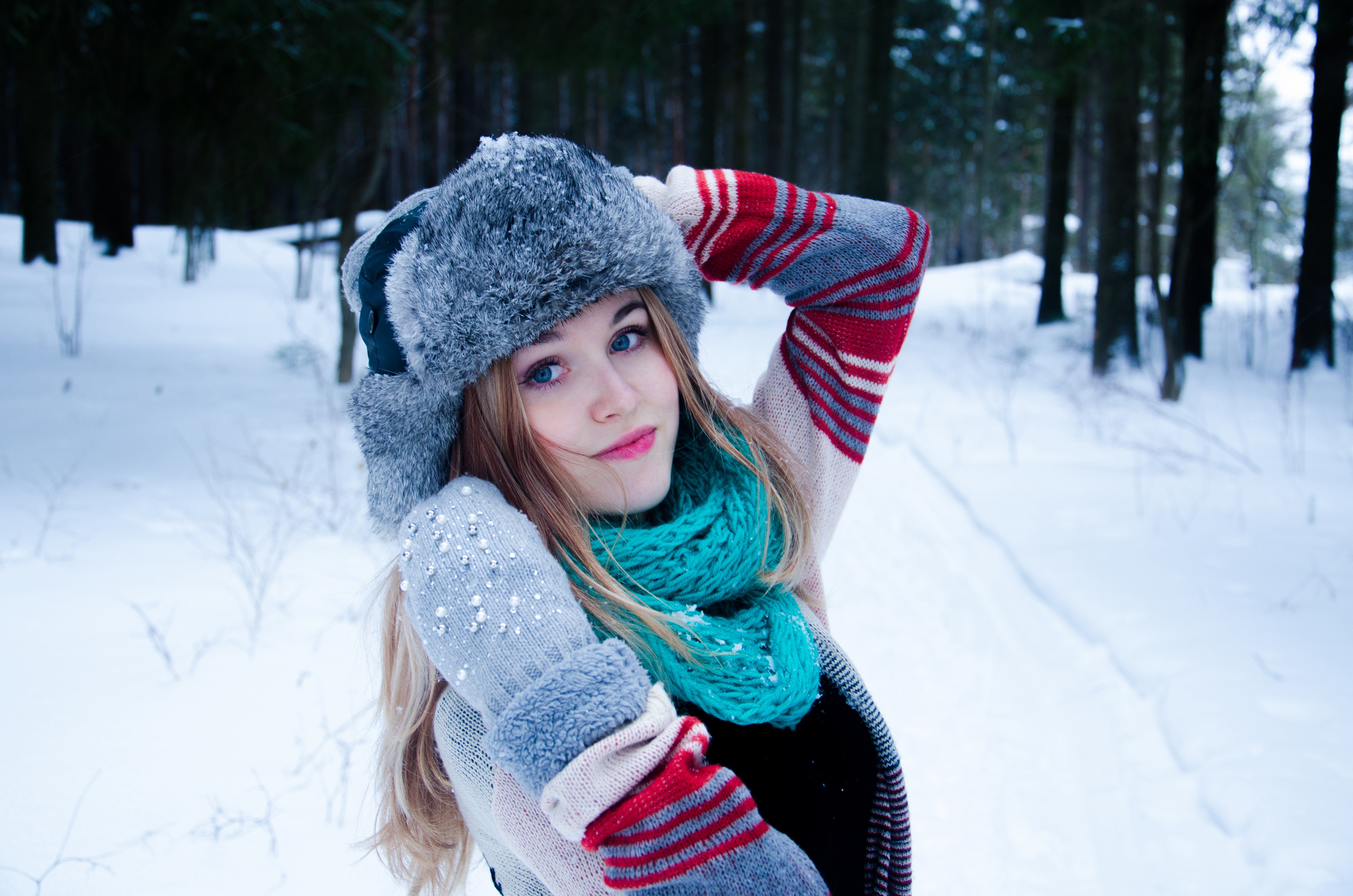Woman with blonde hair and blue eyes in winter forest HD Wallpaper