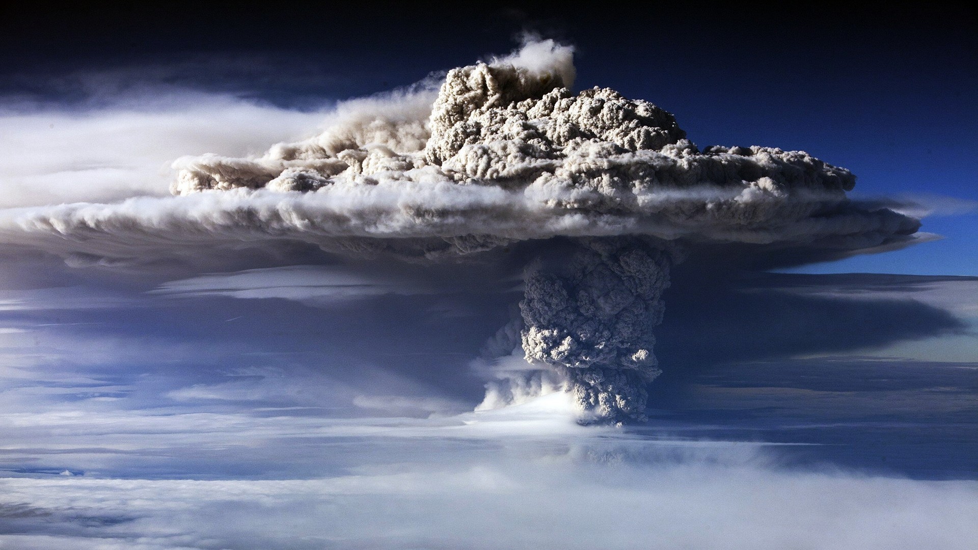 Volcanic eruption spewing ash cloud into the sky HD Wallpaper