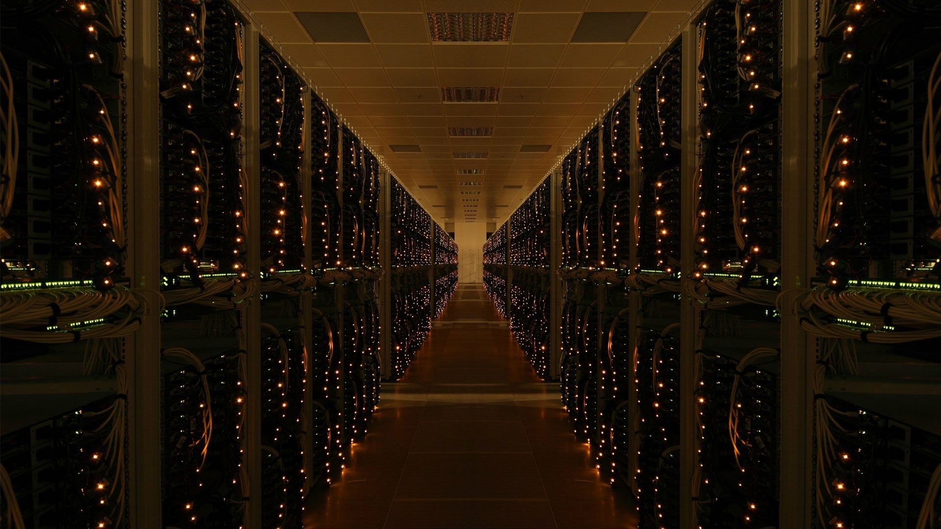 Server room hallway with rows of blinking LEDs HD Wallpaper