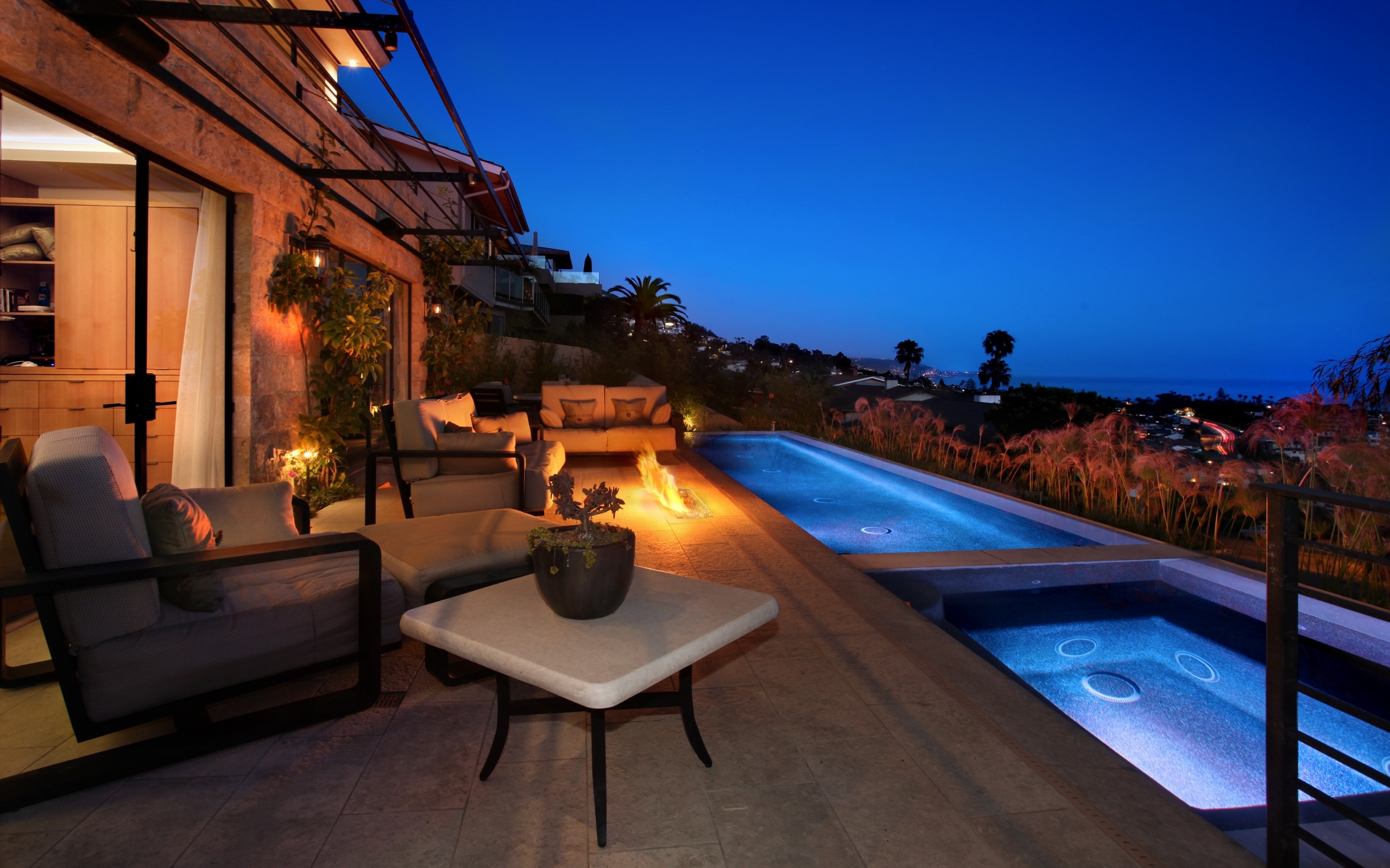 Luxury patio with infinity pool at night HD Wallpaper