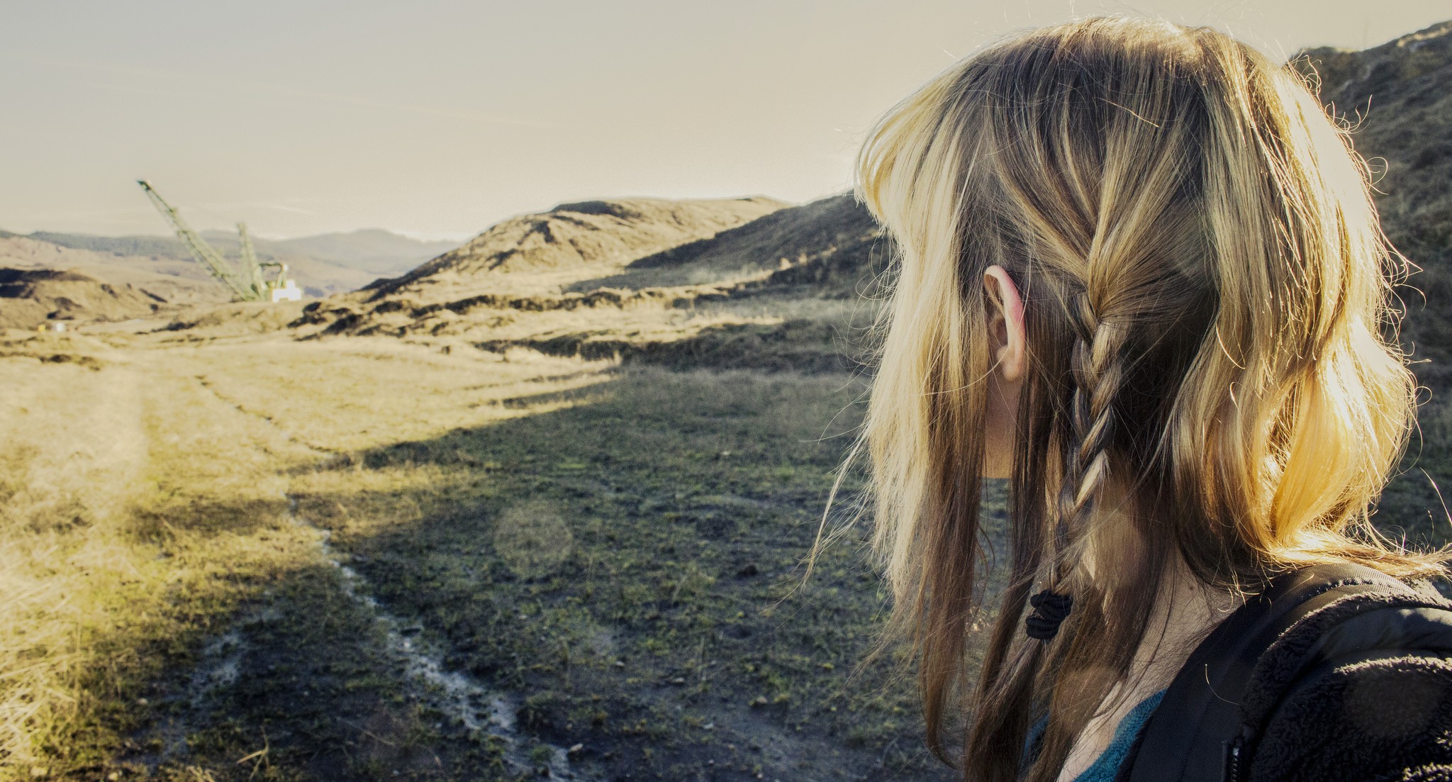Woman with blonde braids in a natural landscape HD Wallpaper