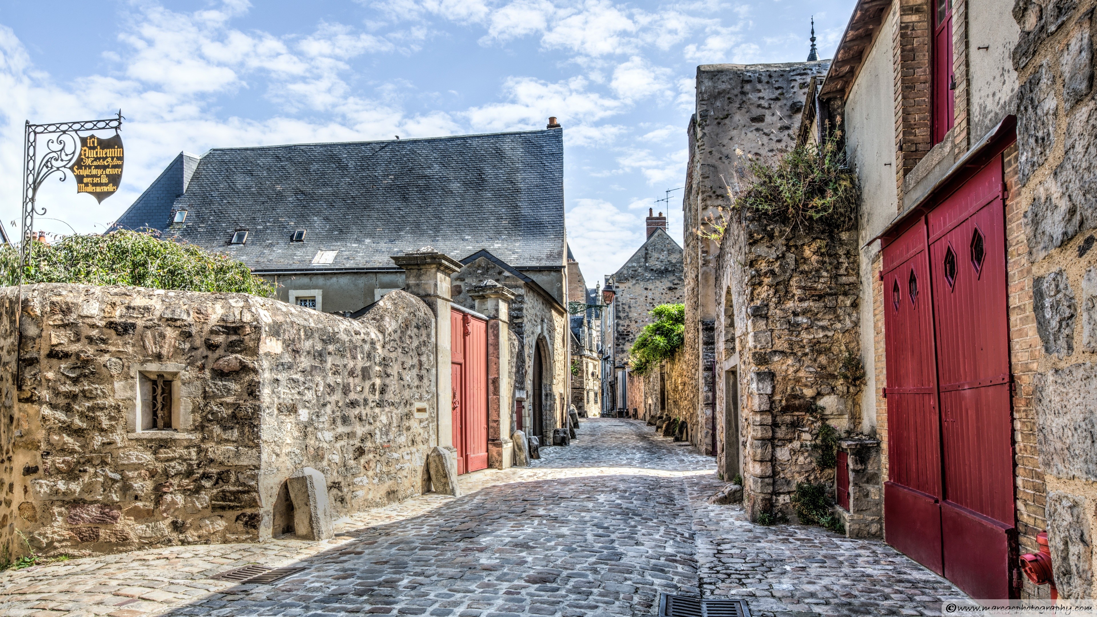 Cobblestone street in a historic European town HD Wallpaper