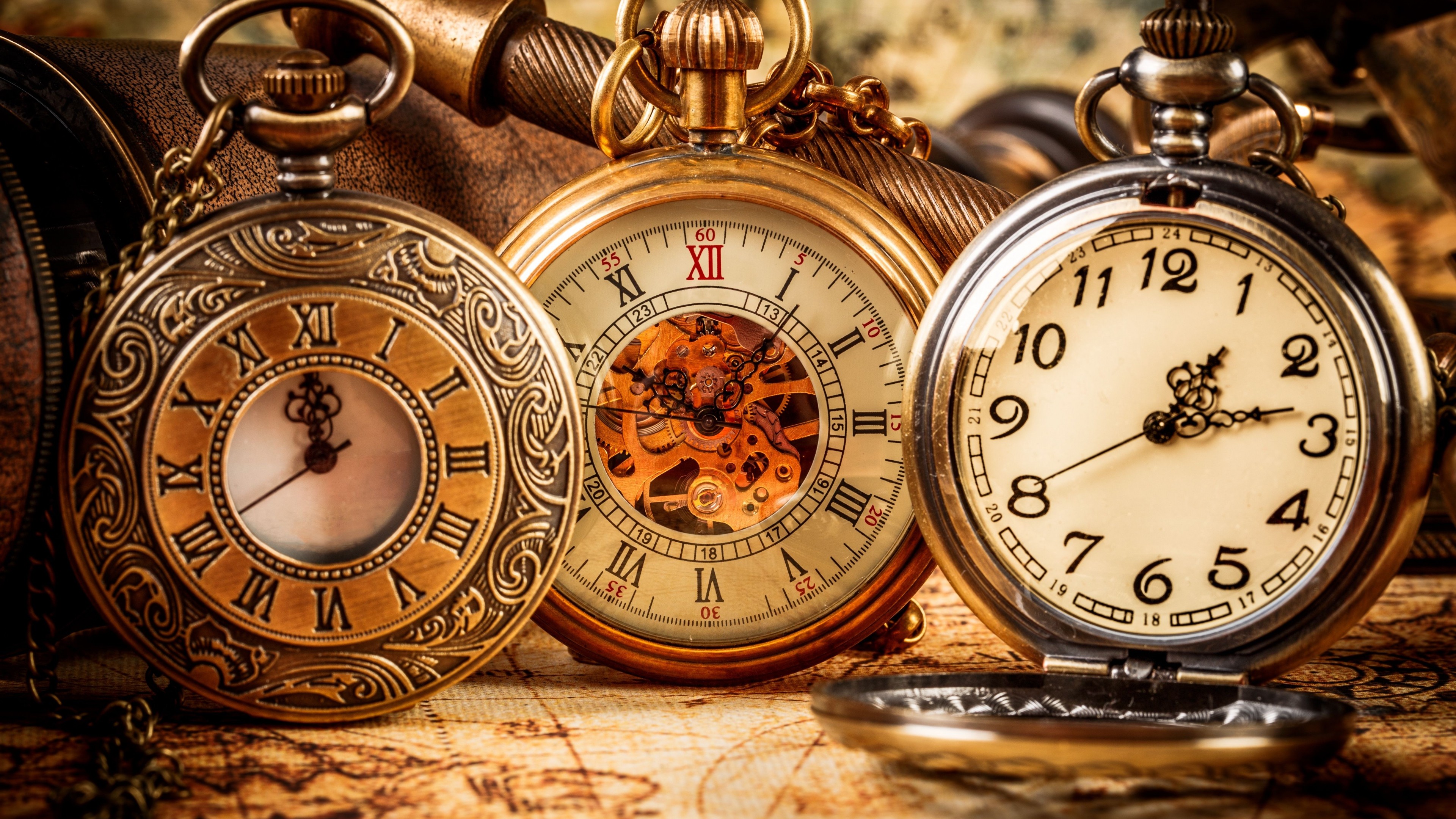 Three antique pocket watches on a map HD Wallpaper