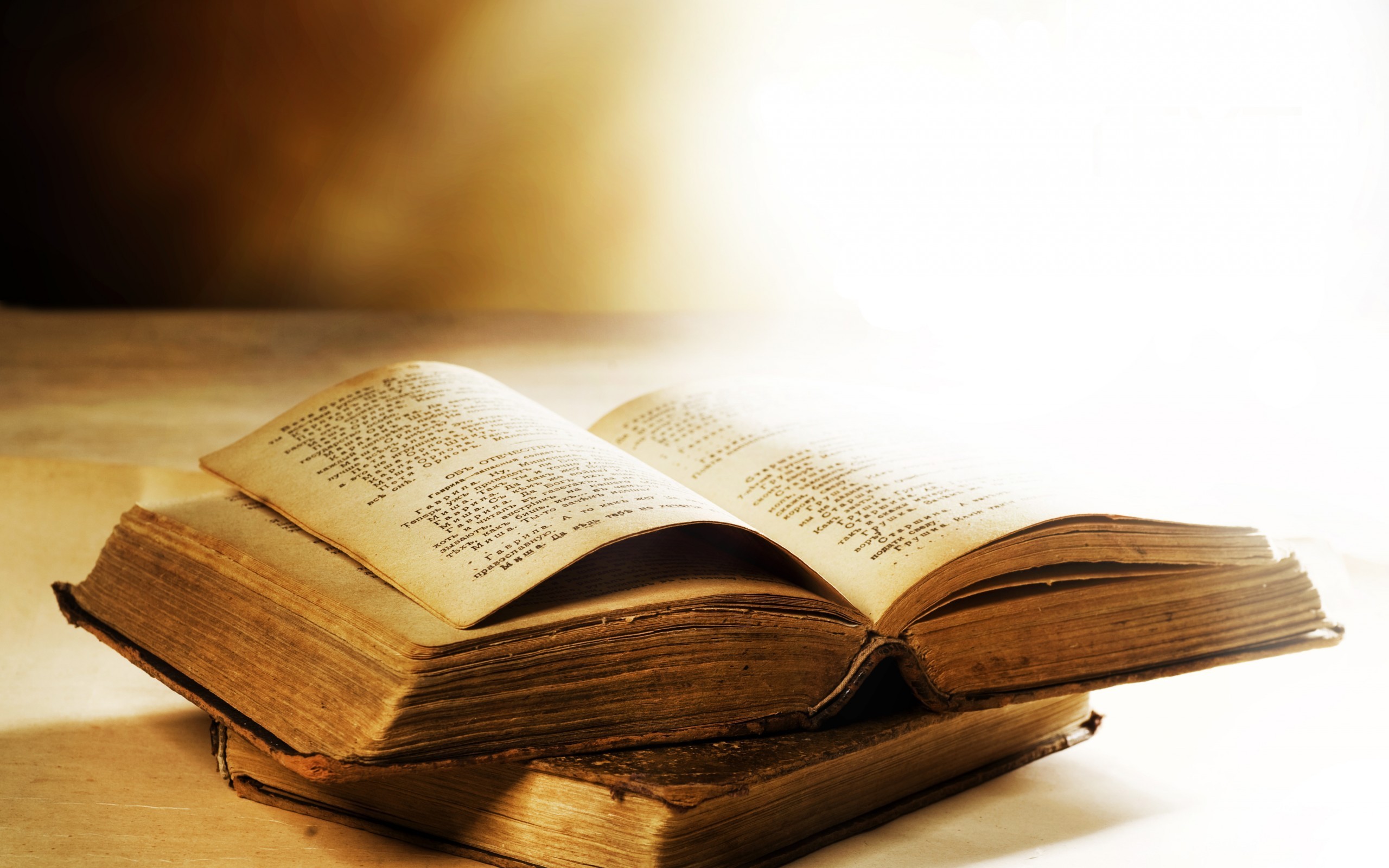 Stack of old books, one open HD Wallpaper
