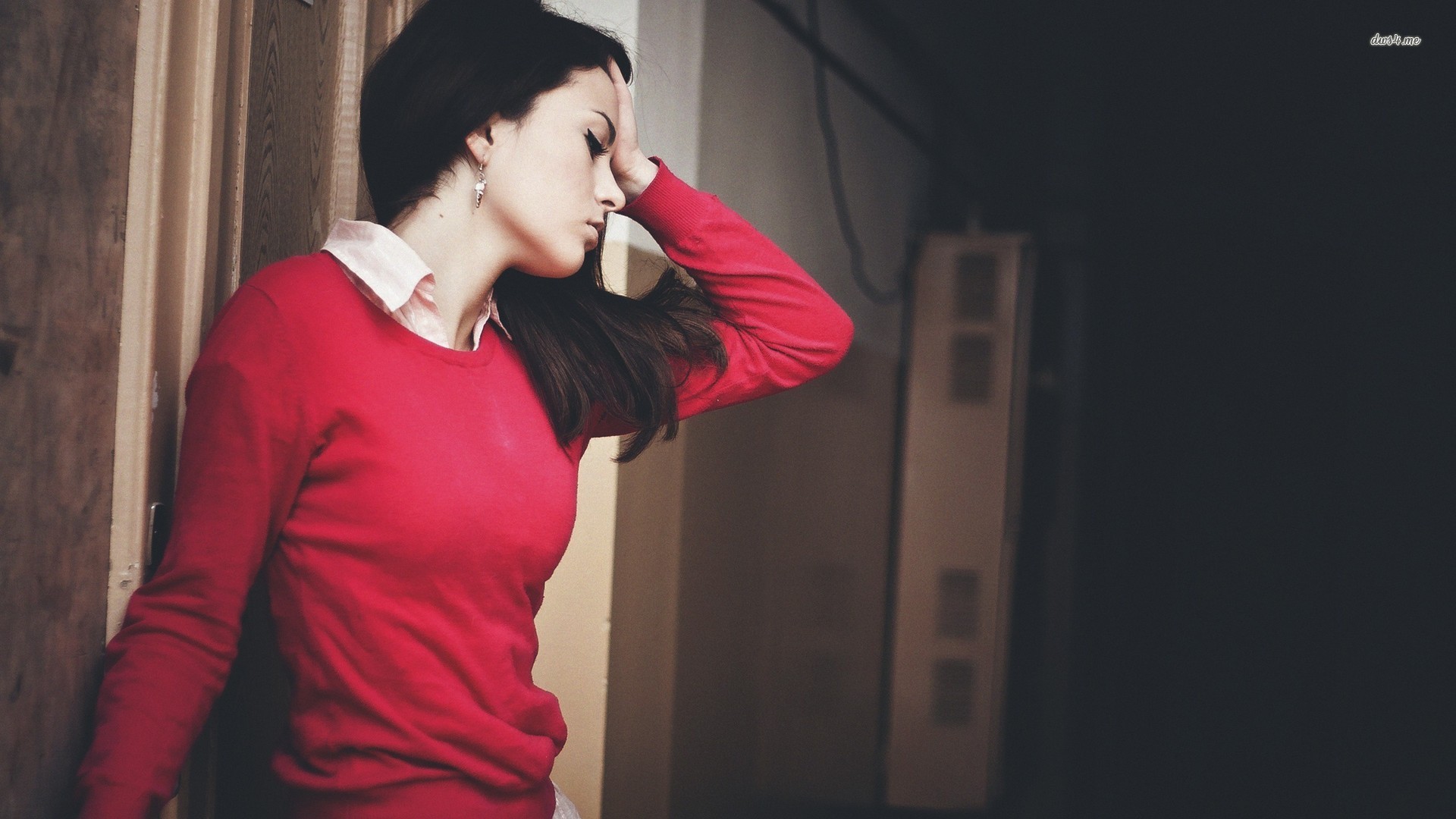 Woman in red sweater leaning against a door HD Wallpaper