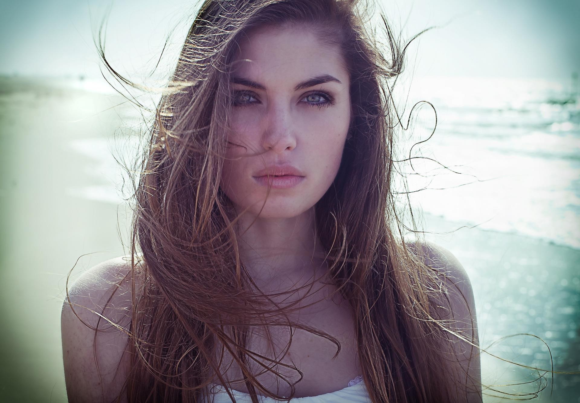 Woman with long brown hair on a beach HD Wallpaper