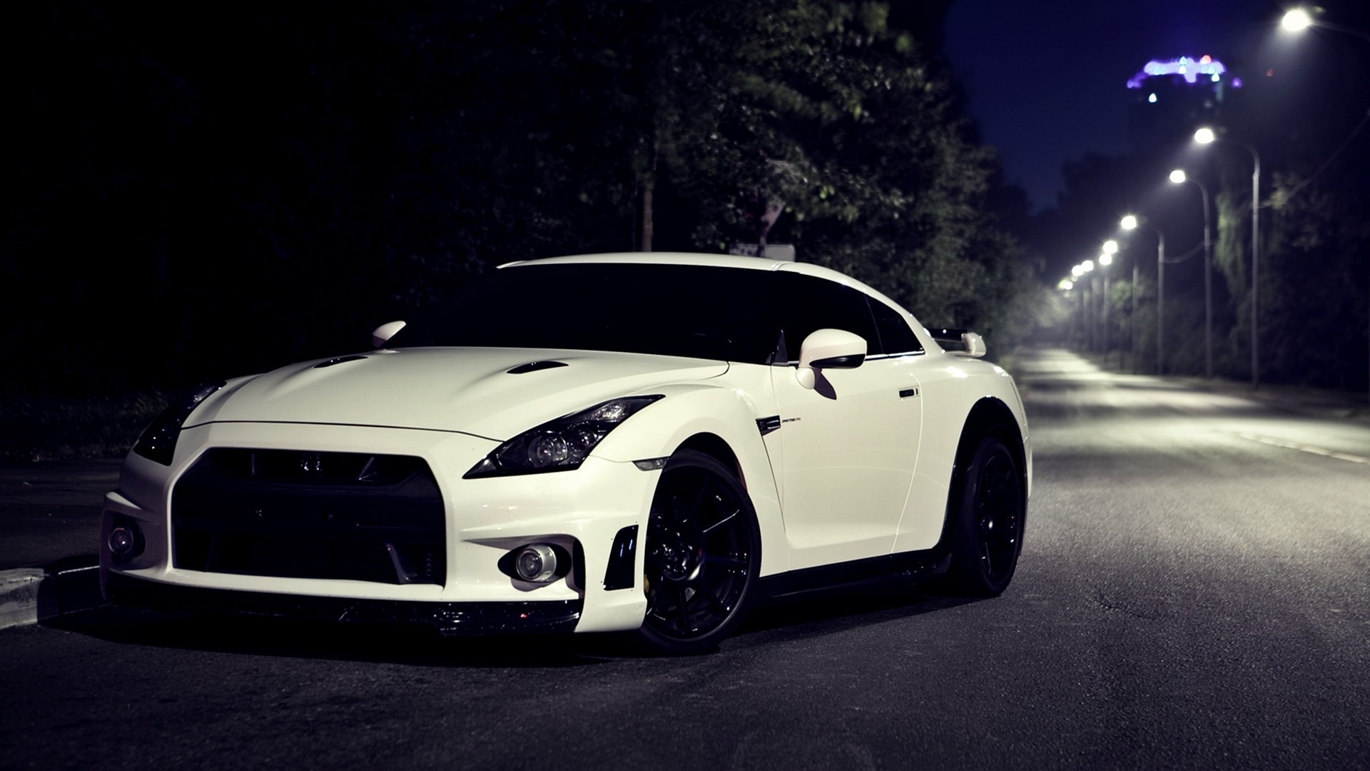 White Nissan GT-R parked on a street at night HD Wallpaper